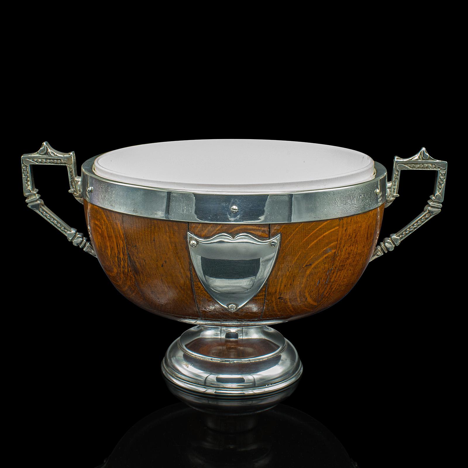 This is an antique trophy bowl. An English, oak and silver plated decorative dish by George Goodfellow & Sons of London, dating to the Edwardian period, circa 1910.

Fascinating appearance, with delightful quality and colour
Displays a desirable