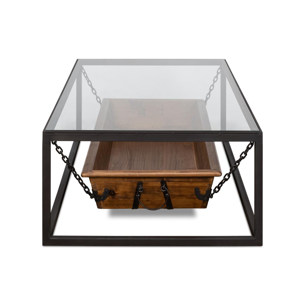 An antique trough coffee table. This piece features an antique trough suspended by a metal base with a glass top. It is truly a conversation starter where antique meets modern industrial. 

Dimensions: 51