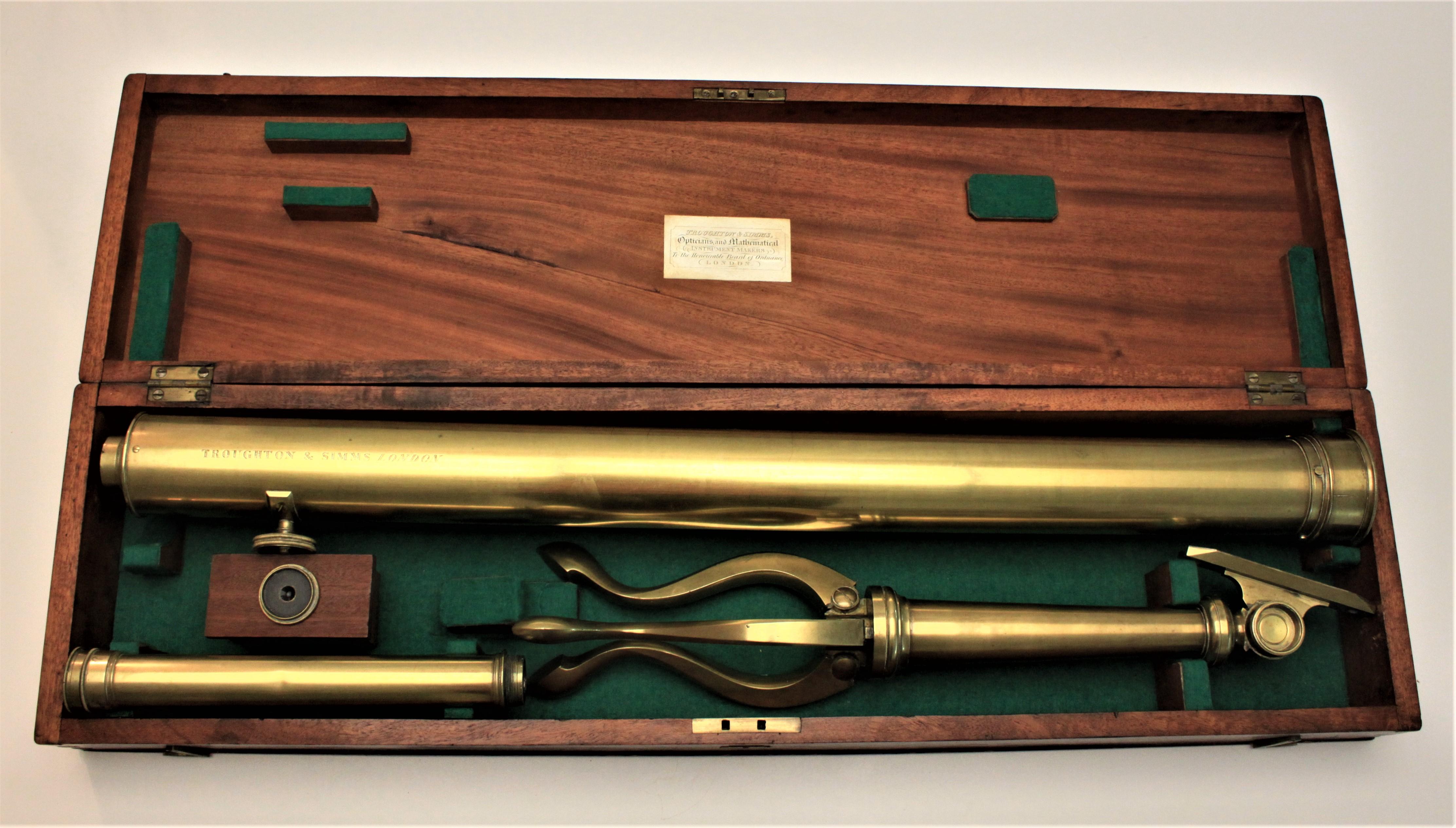 Made in London, England by the noted scientific instrument maker Troughton & Simms, this brass astrological telescope comes complete with its solid brass tripod and one additional eye piece, in addition to its original fitted wooden box. The