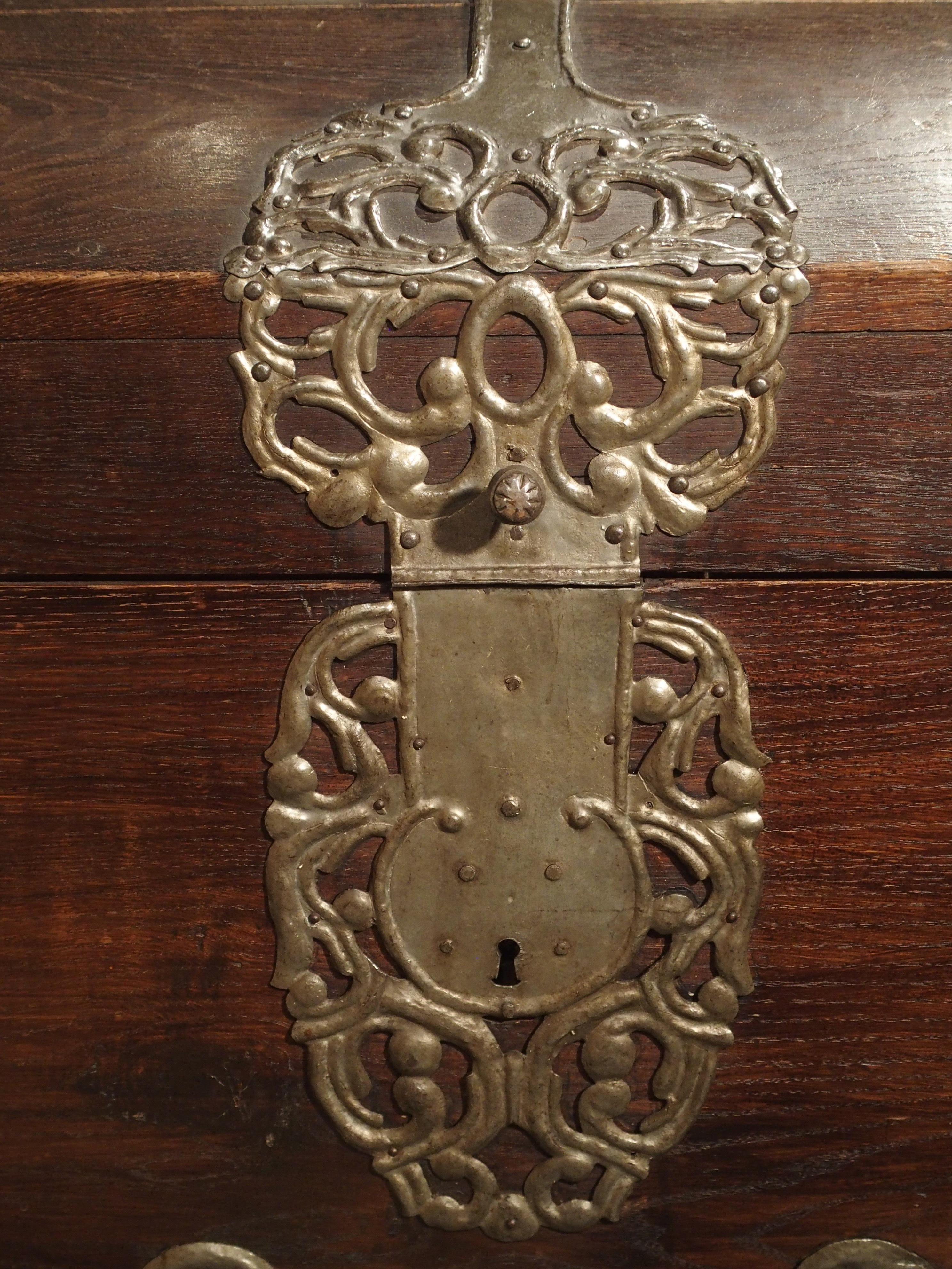 Known as a barock runddeckeltruhe (Baroque round lid trunk), this wooden trunk with its rich oak finish and impressive polished wrought iron strappings was produced in Northern Germany, circa 1720.

At the apex of the dome top there are three