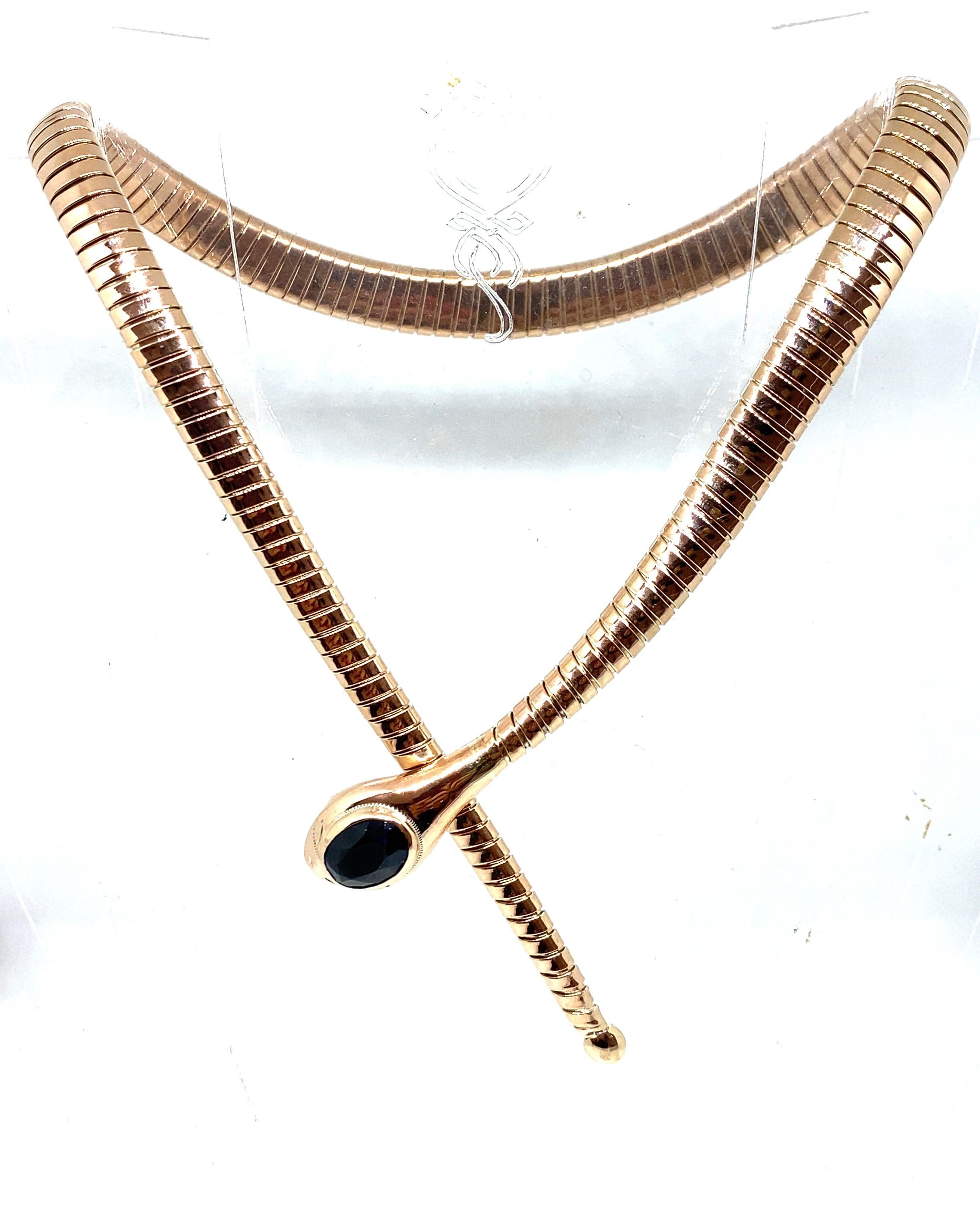 An iconic Tubogas necklace circa 1900's made in 14k rose gold. It features an head snake embellished by a Dark Blue Sapphire.  

CONDITION: Pre-owned - Very Good
METAL: 14k Gold
DESIGN ERA: 1900'
MEASUREMENTS: Long 42 cm (16,53 inches)
GROSS WEIGHT: