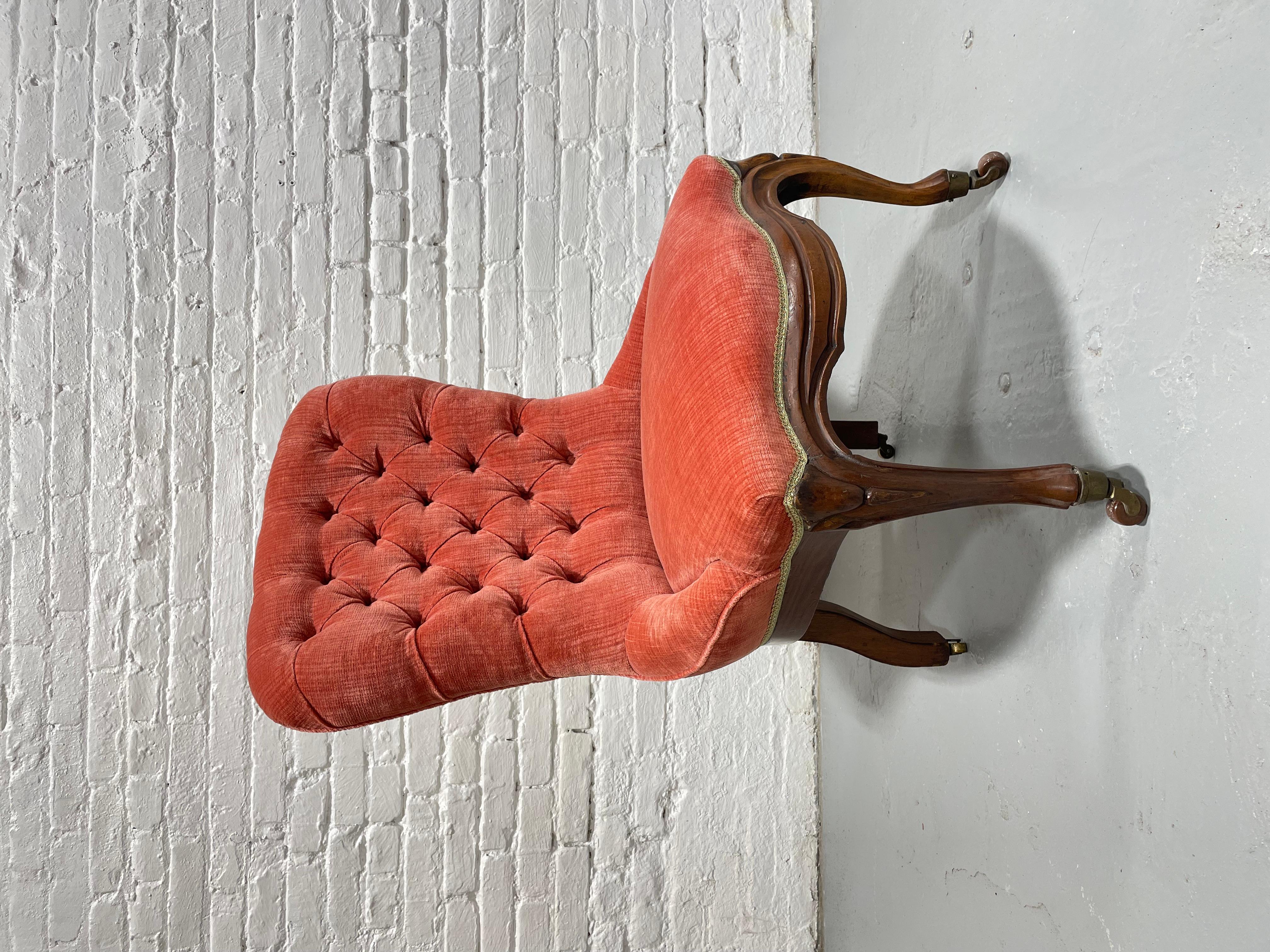 Antique Tufted Mahogany French Slipper Side Chair. Remarkable condition and perfectly tufted. The carved detail is lovely and the chair sits on small castors. The seat has been reupholstered at some point in a lovely pink soft velvet and is in
