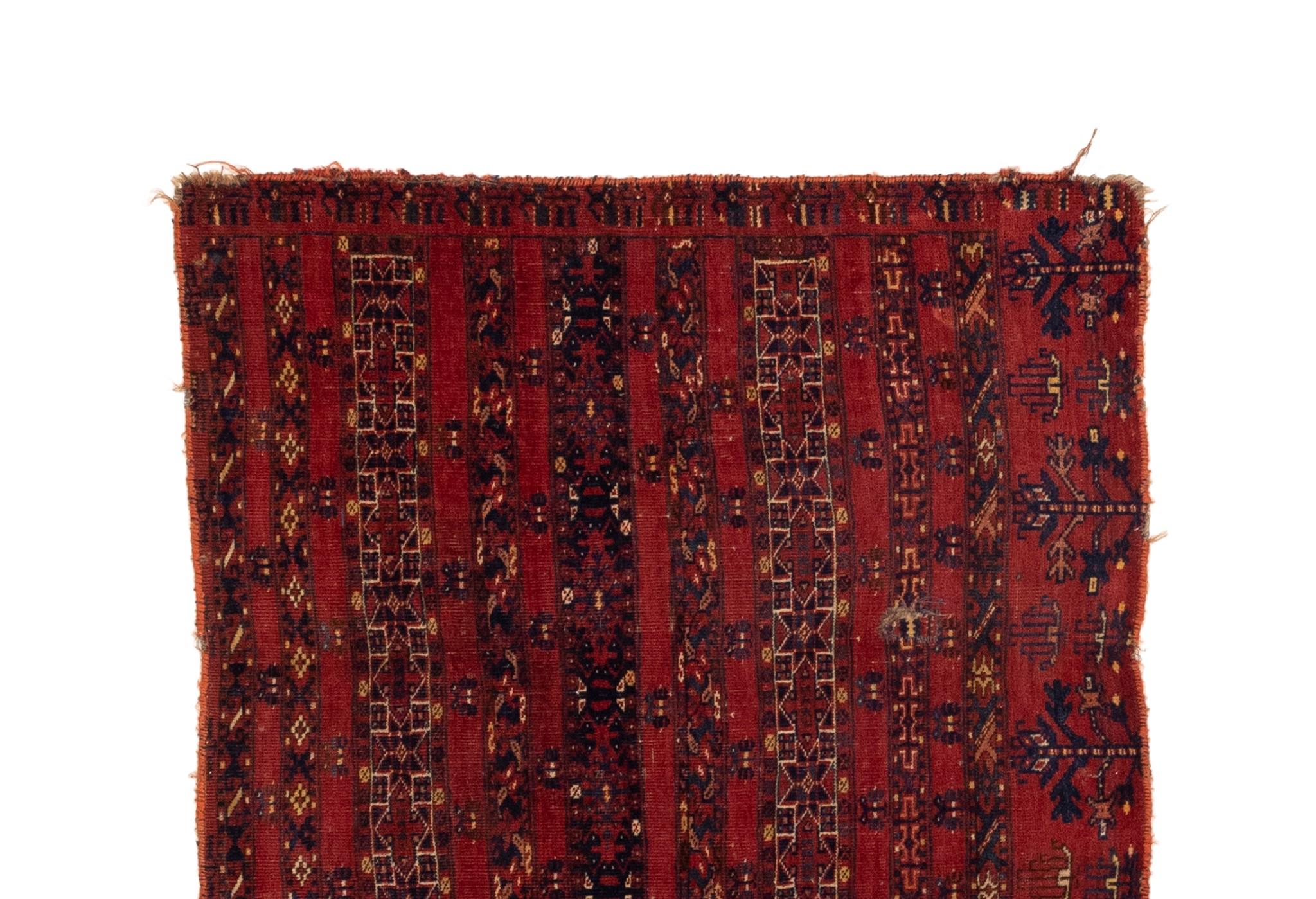This Antique Turkaman Trival rug is a fine example of a piece that stands out for its rare element panels, vibrant red background color, and fine weave. The vintage rugs in our collection have a rich and deep color palette and feature characteristic
