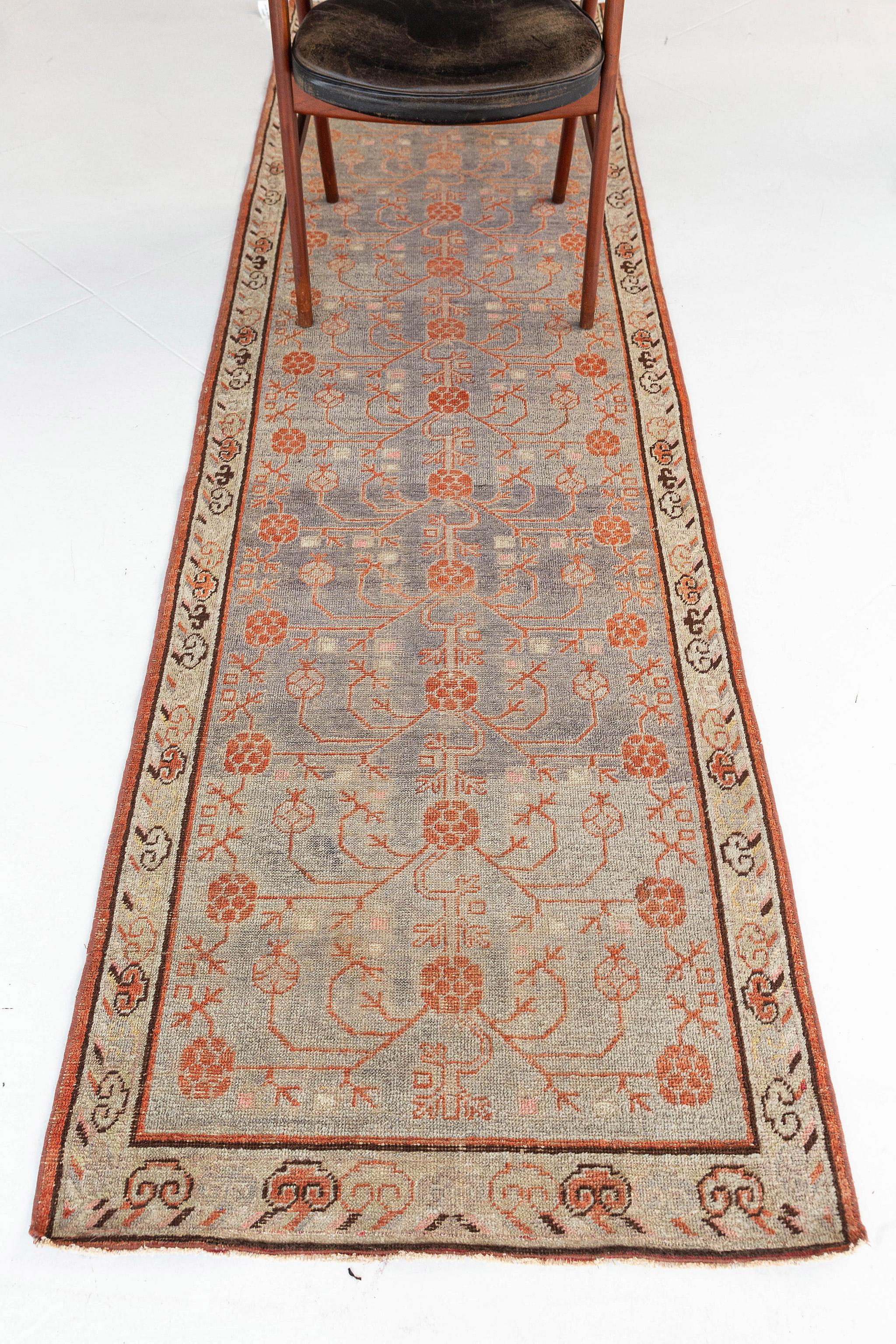 A meticulously hand-spun wool Khotan design creation has come and flexed its versatility.  Stylized motif and symmetric geometrical designs in a gradient of midnight and sand field manifest the entire pattern of the rug. This rug is flexible for any