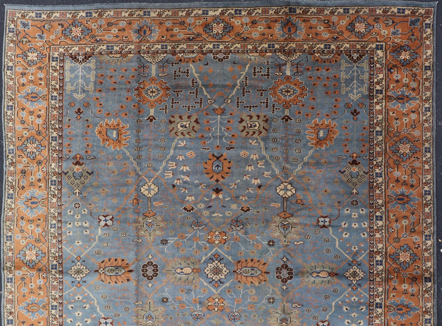 Keivan Woven Arts Antique Turkish All Over Oushak Rug in Blue Background & light Cognac Colored Border . Keivan Woven Arts / rug 16-1006, country of origin / type: Turkey / Oushak, circa Early-20th Century.

Measures: 9'8 x 13'3

Floral and