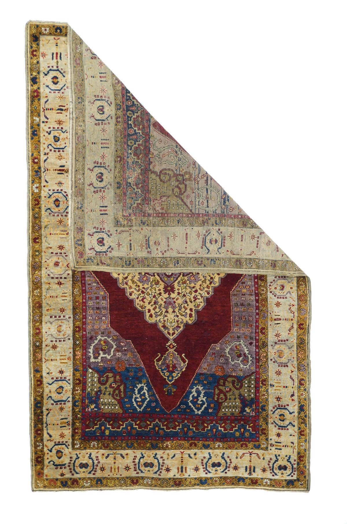 Antique Turkish Anatolian Rug, Measures : 3'9'' x 6'1''. All Anatolians are Turkish. An ecru strip style border of faceted parenthesis pairs frames the red Tabriz-esque field with blue-to-green abrashed corners and an ivory stepped and lobed lozenge