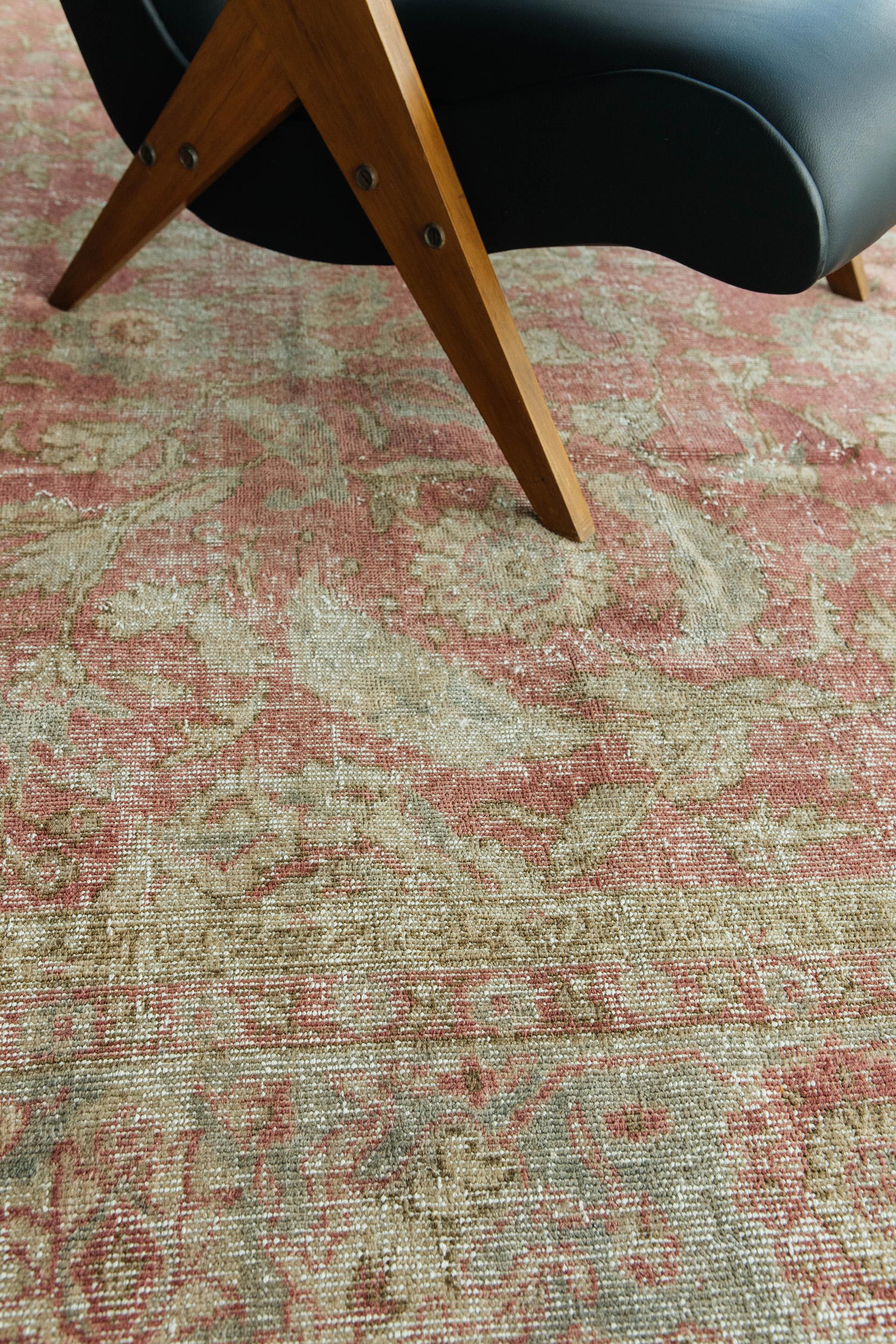 Soft cranberry red with ivory, gray and walnut brown tones. All-over field pattern of curvilinear leaf, blossom and palmette grace this time-touched rug. The elegance and sophistication of the design remains clear in spite of foundation reveal. This