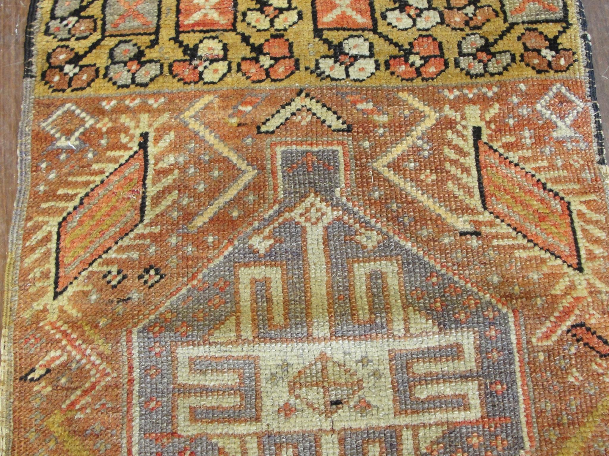 Yastik or pillow or bloster cover, Ghiordes. It has the fortunate of still having the end original Kilim on both ends although it is not perfect. Beautiful distinctive Anatolian motives and soft color, depicts in very center a small lozenge