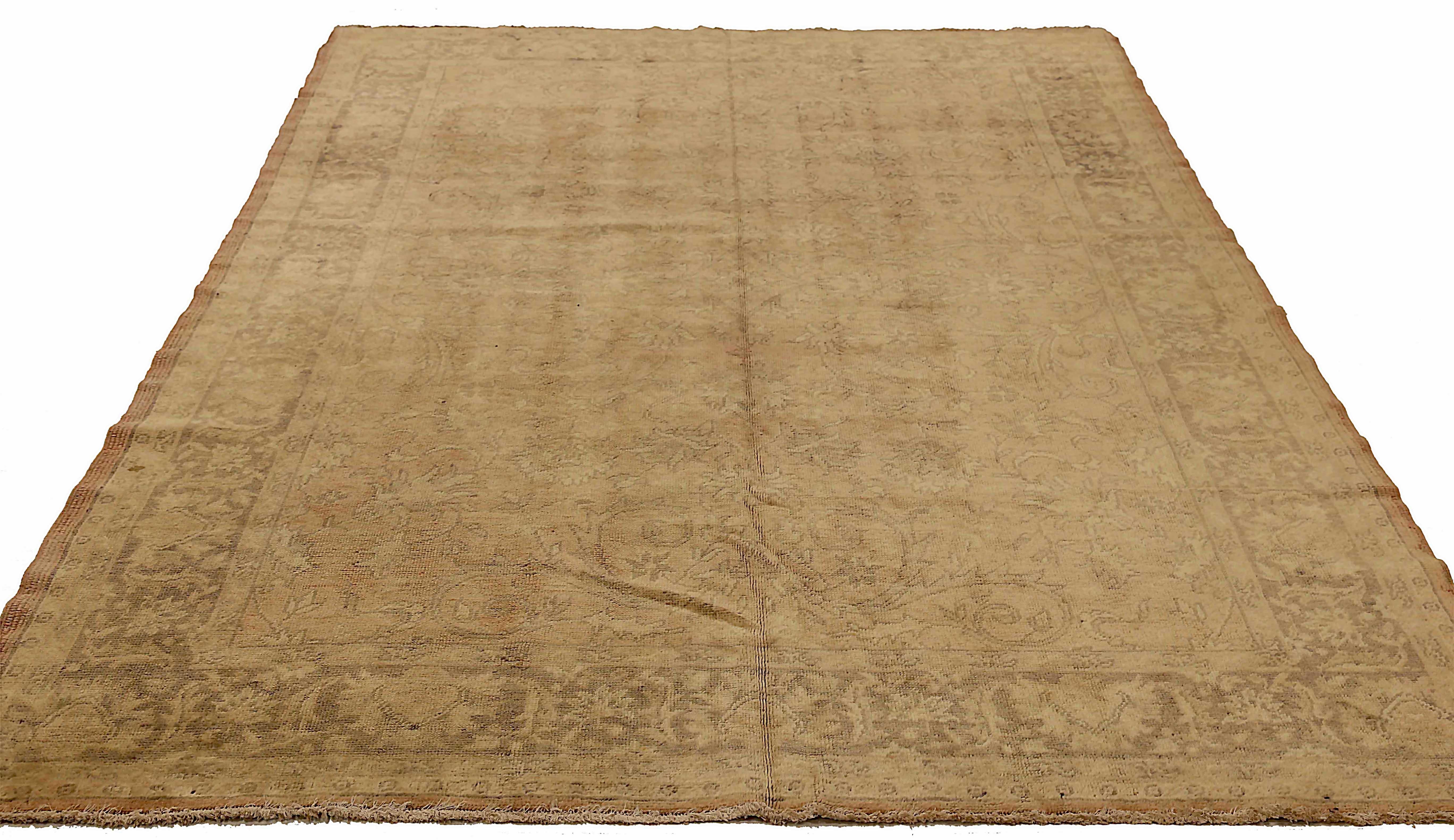 Antique Turkish area rug handwoven from the finest sheep’s wool. It’s colored with all-natural vegetable dyes that are safe for humans and pets. It’s a traditional Oushak design handwoven by expert artisans. It’s a lovely area rug that can be