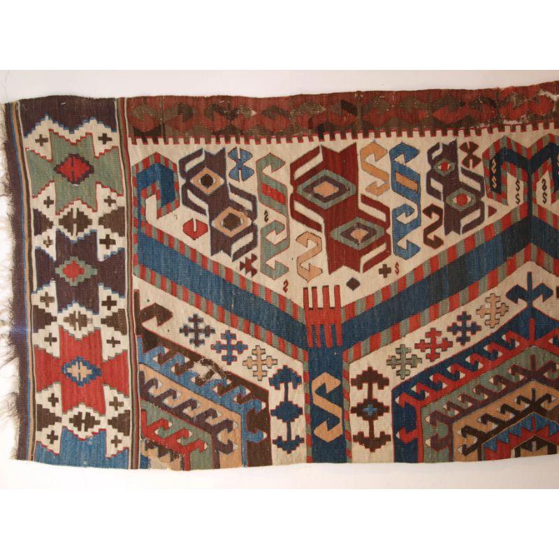 Antique fragment of a kilim by the Aydinli tribe of South West Anatolia

This kilim was woven in two parts on a narrow loom and only one half now survives. The kilim is original in lengths as knotted end finishes are present in places at both ends.