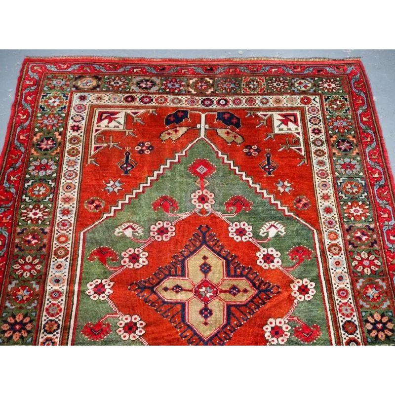 Antique West Anatolian rug from the small village of Dazkiri which lies on the road from Denizli to Sparta. The rug is of a design unique to this village, with the small central medallion surrounded by flower heads. This rug is most unusual in