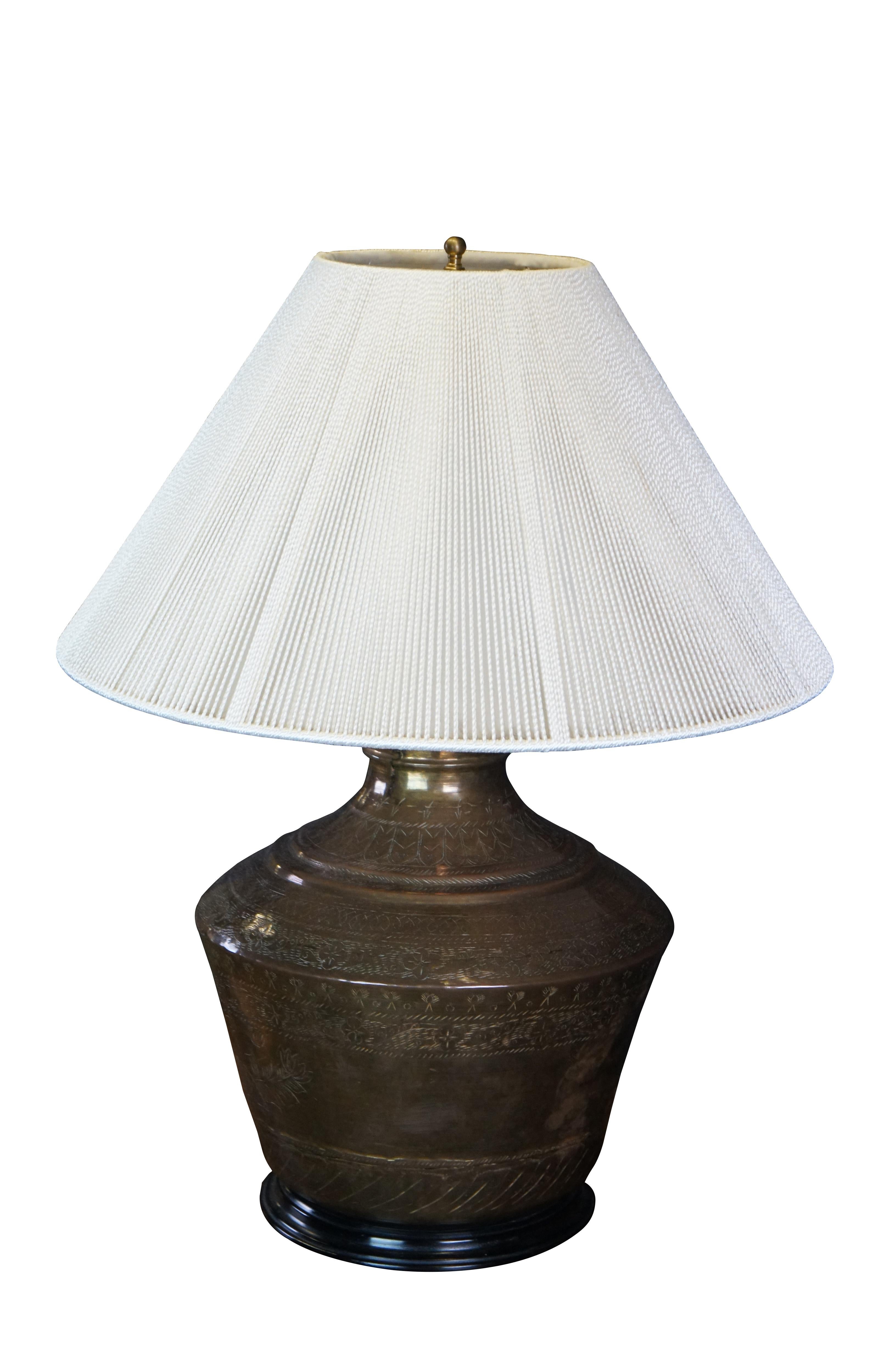 Antique Turkish brass reclaimed urn / jug / vase table lamp featuring etched floral and bird theme with dovetailed construction, wood base, and braided string shade.

Dimensions:
26