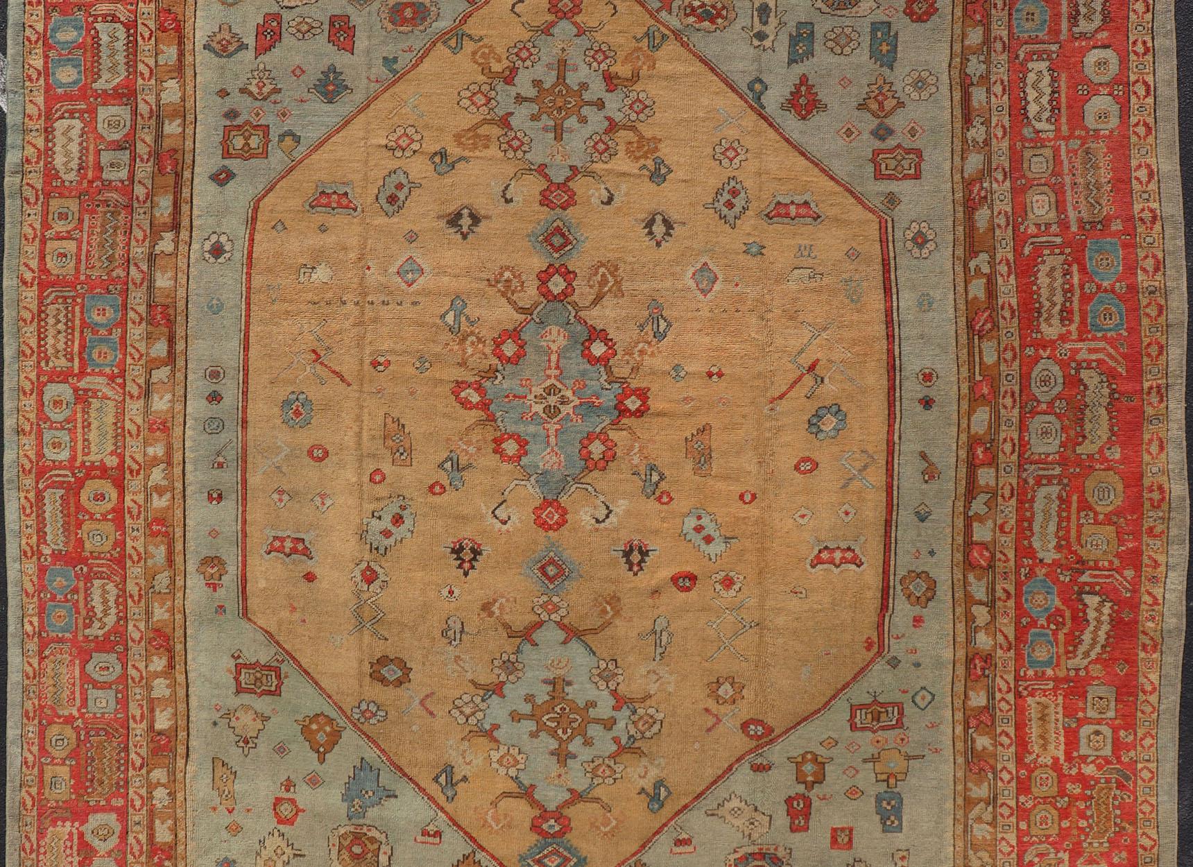 Antique Turkish Ghoirdes Oushak Rug With Medallion in Sky Blue, Tan, and Red. Keivan Woven Arts / Rug / S12-0308 / country of origin / type: Turkey / Oushak, circa 1880. Antique oushak, Turkish oushak, Turkish Ghoirdes.
Measures: 12.2 x
