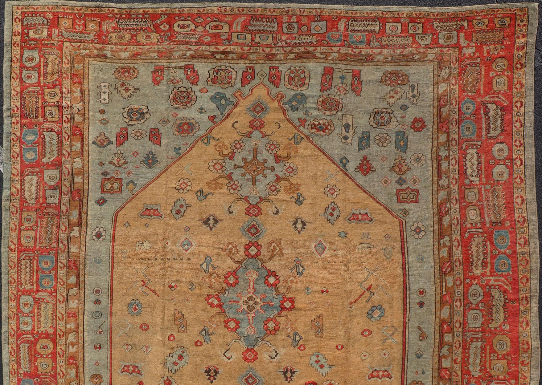 Hand-Knotted Antique Turkish Ghoirdes Oushak Rug With Medallion in Sky Blue, Tan, and Red For Sale