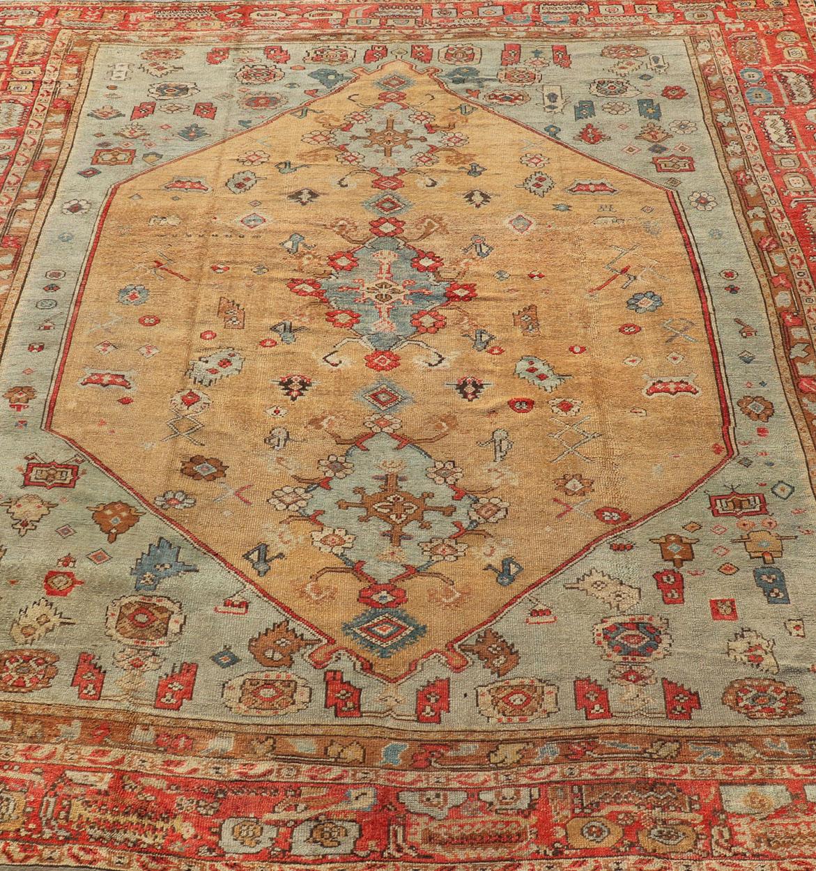 Wool Antique Turkish Ghoirdes Oushak Rug With Medallion in Sky Blue, Tan, and Red For Sale