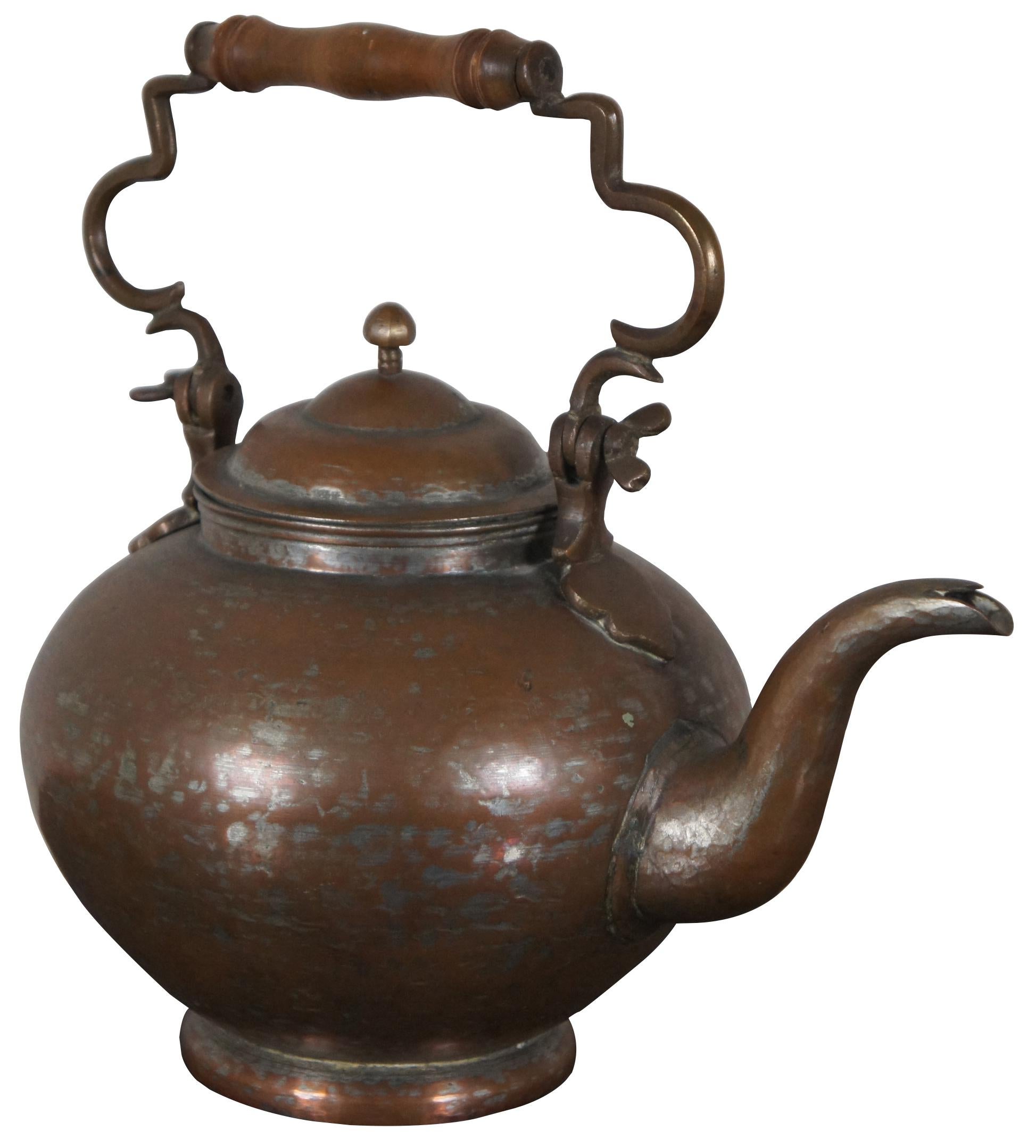 Antique copper clad gooseneck tea kettle with lid and turned wood handle.

Measures: 13” x 9” x 9.5” / Height of Handle – 4.75” (Width x Depth x Height).