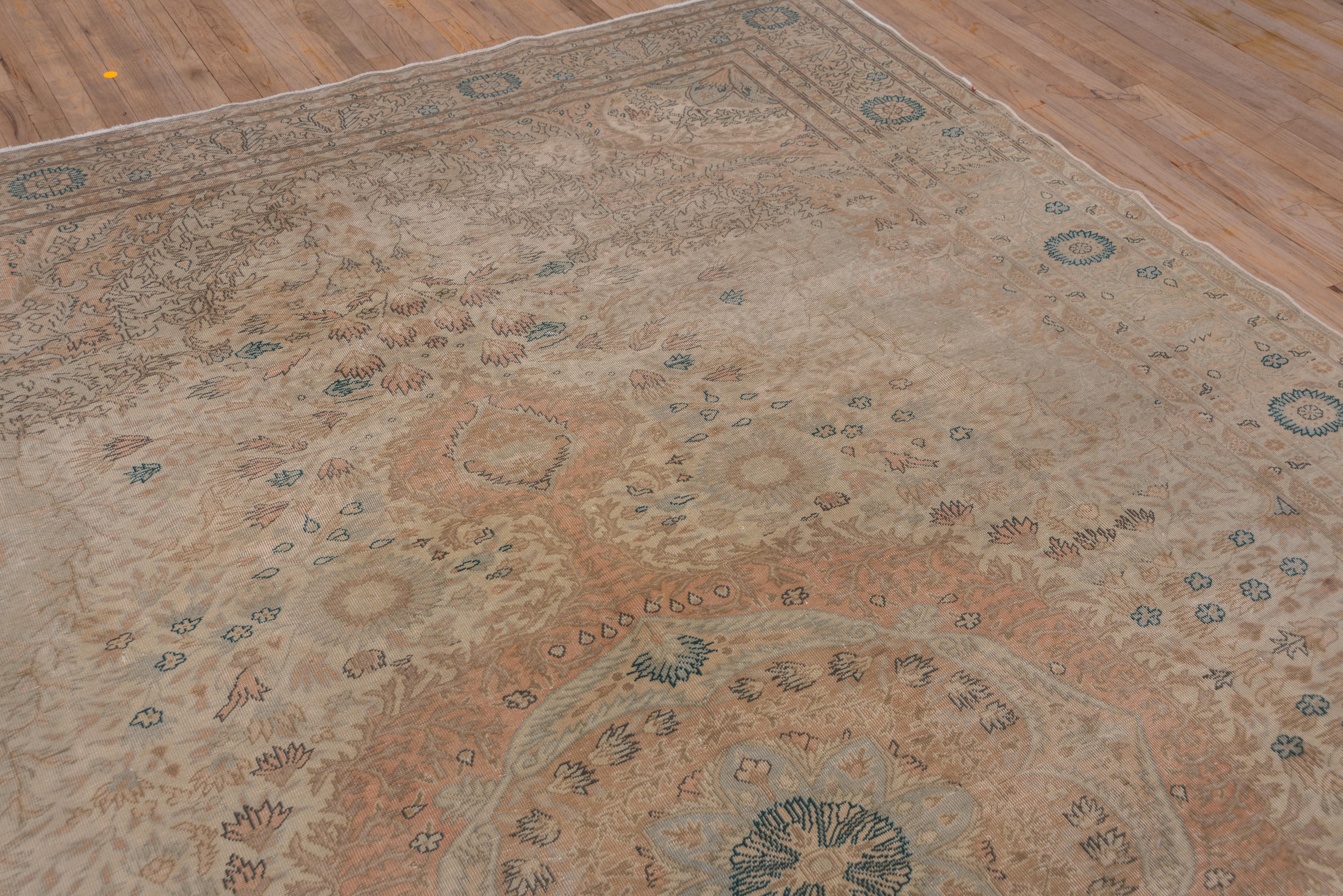 Kaisary and Sivas are thee two eastern Turkish cities whose rugs are in a Persian urban style. This Kaisary shows an eggshell ground with a layered floral wreath round pendanted medallion in pale blue, green and ivory with wine accents. Leaf and