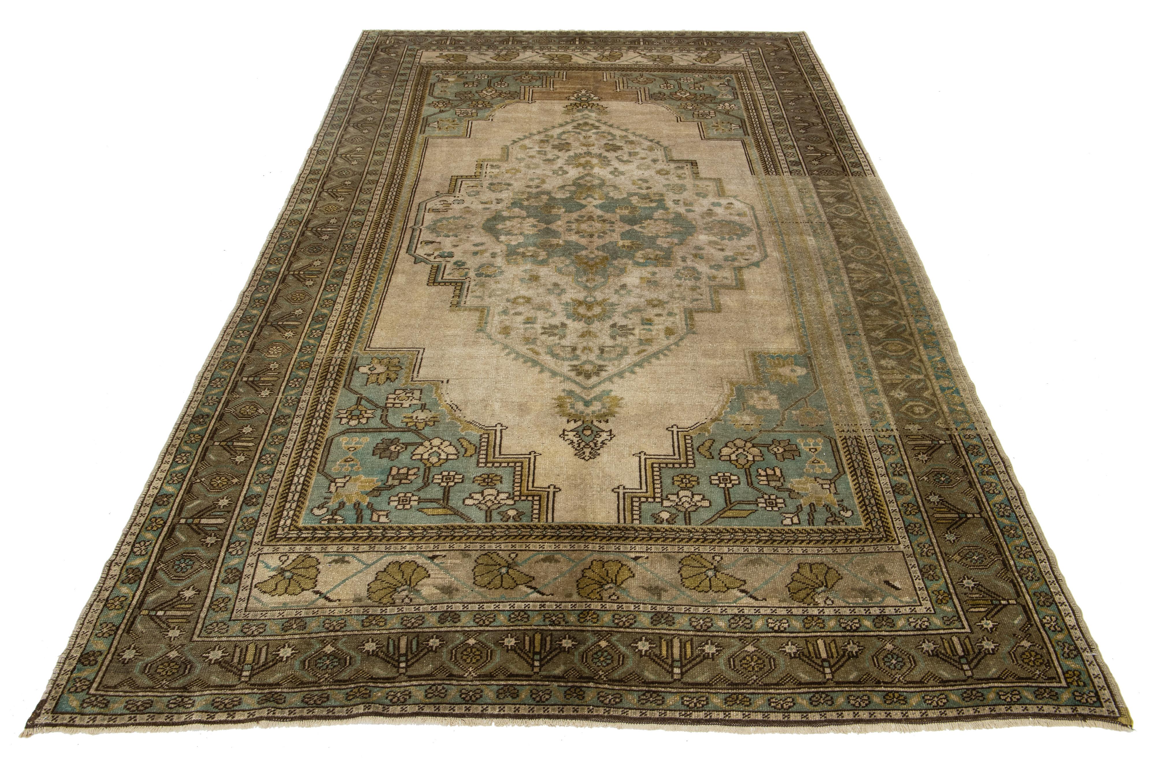 Beautiful Antique Turkish Khotan hand-knotted wool rug with a light brown color field. This Khotan has multicolor accents in a gorgeous all-over medallion floral motif.

This runner measures 6'4