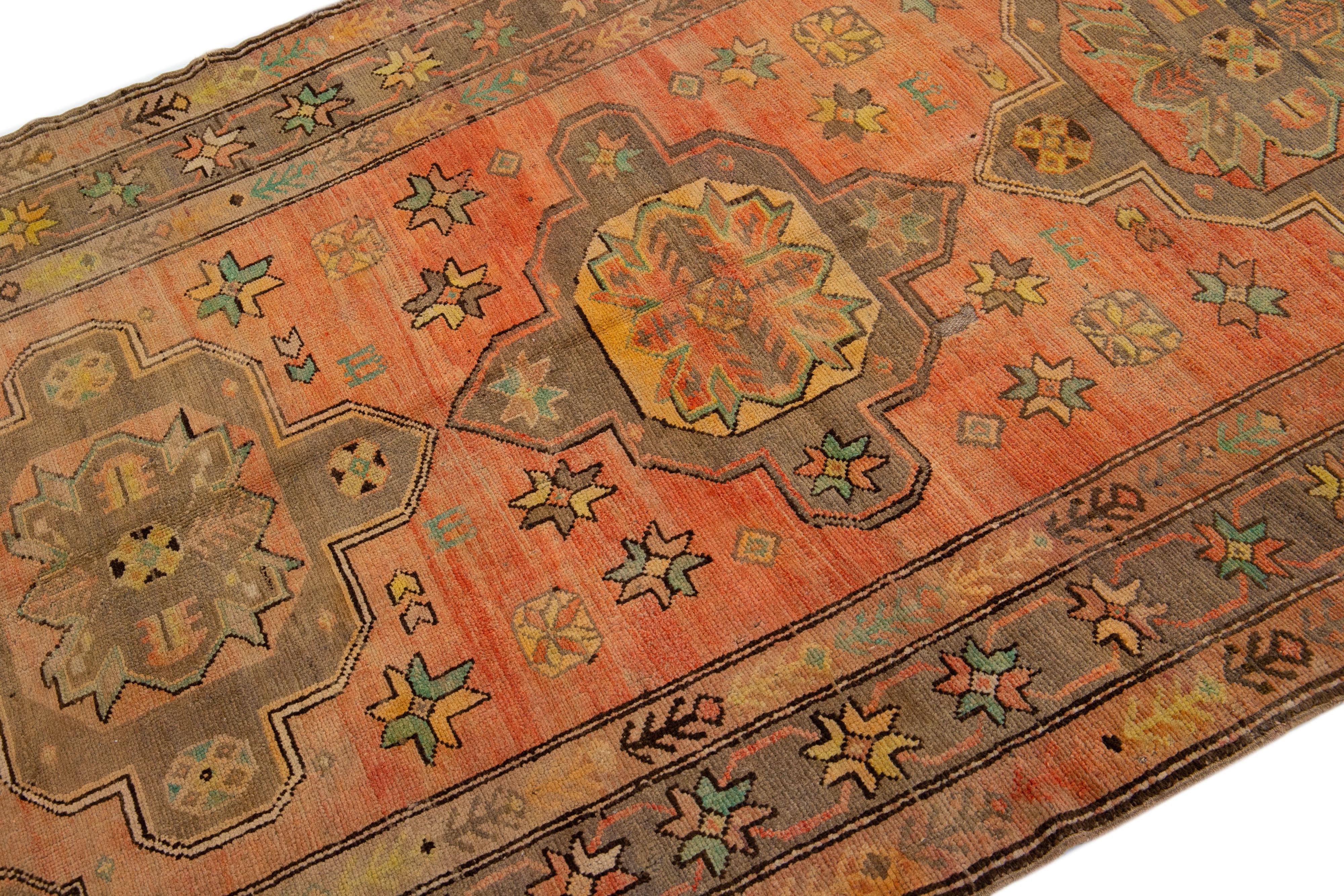 Hand-Knotted Antique Turkish Khotan Handmade Wool Rug with Tribal Terracotta Field For Sale