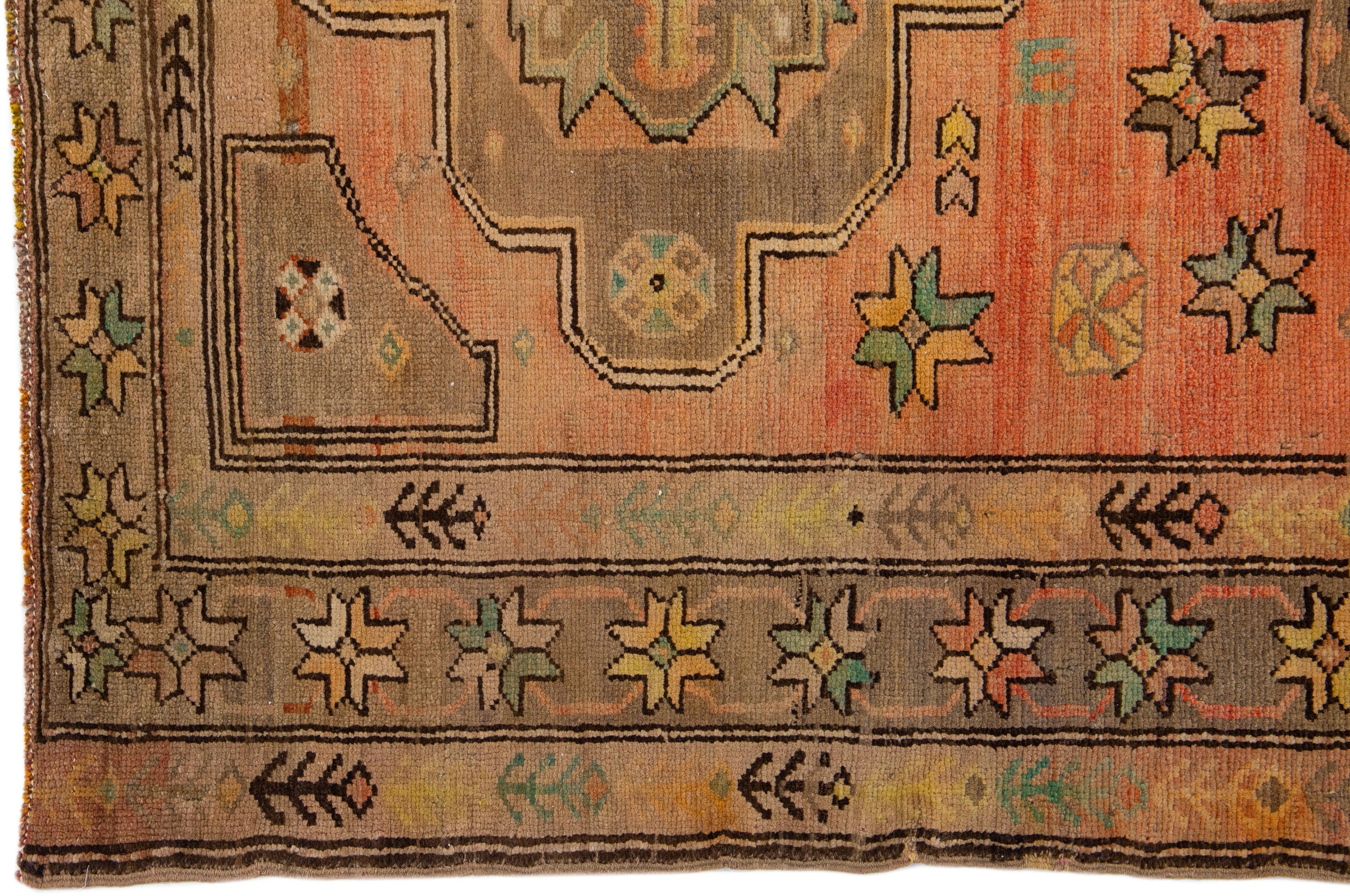 20th Century Antique Turkish Khotan Handmade Wool Rug with Tribal Terracotta Field For Sale