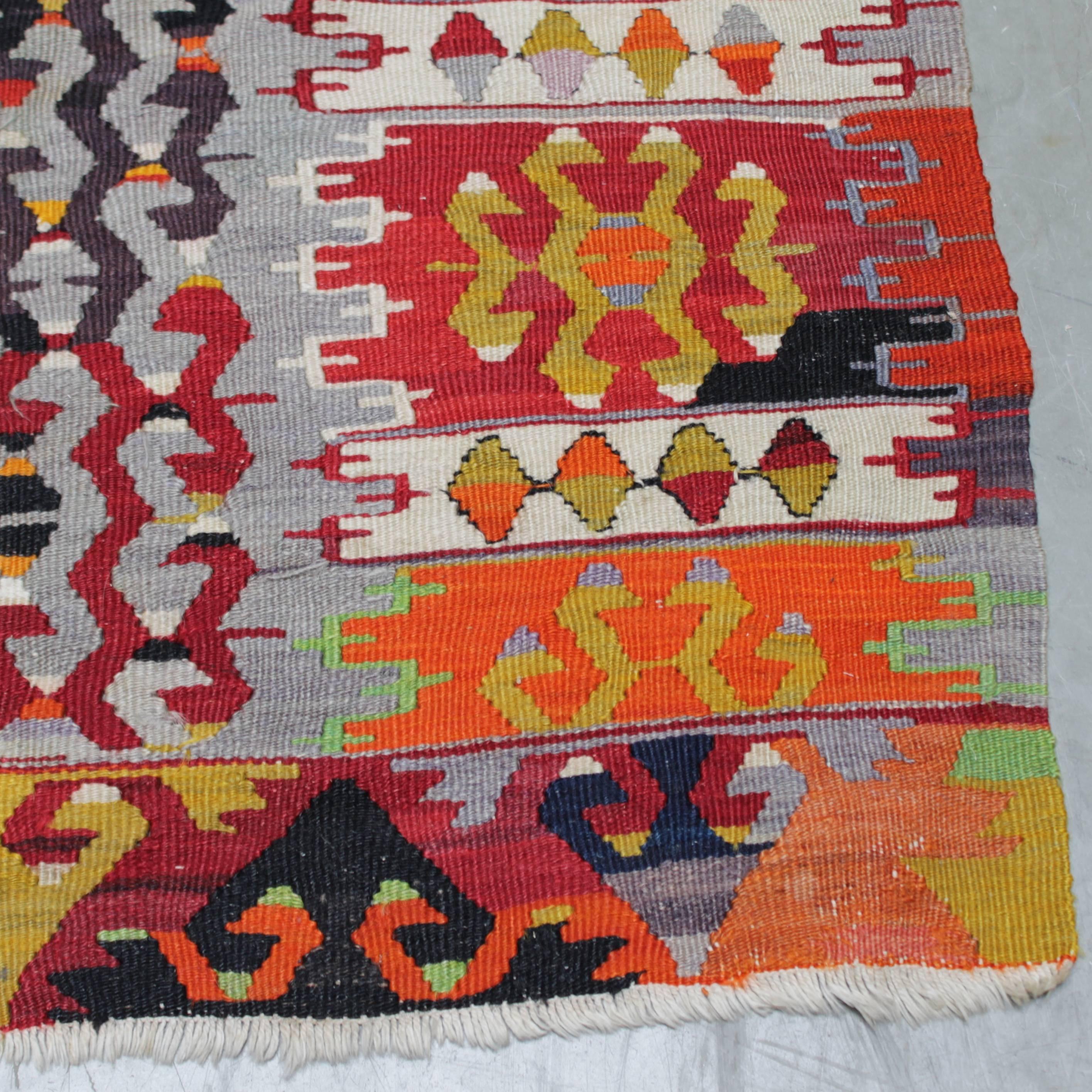 Large colorful vintage Kaysery Cappadocia Kilim, flat-weave rug in a bright multi-color geometric design. Dimensions: 72.8 in. (185 cm) x 98.4 inches (250 cm). Handwoven wool and cotton. Good condition: two small thin and worn spots (see last two