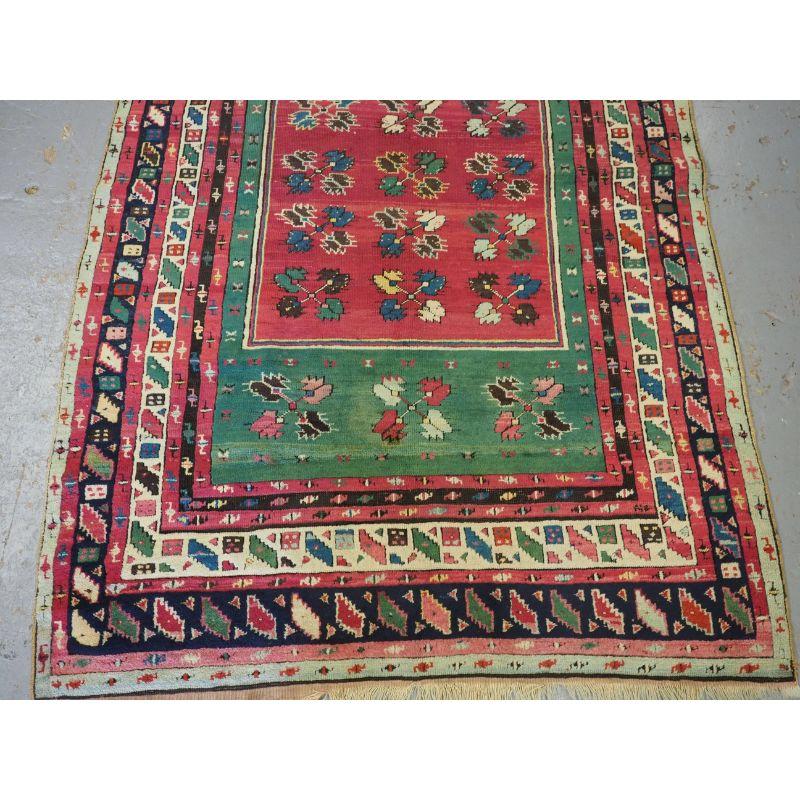 Antique Anatolian Kirsehir village prayer rug of rare form.

2nd Half 19th century.

An interesting village prayer rug with floral carnation design to the field and a compartment mihrab design within the field. The rug has superb colour with a