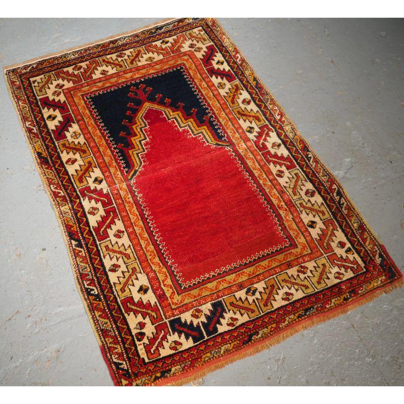 Antique Central Anatolian Konya region village prayer rug.

A nice small example of a Konya village prayer rug with a classic design, the rug has a clear red field with indigo blue above the mihrab. The border is well drawn with a simple leaf