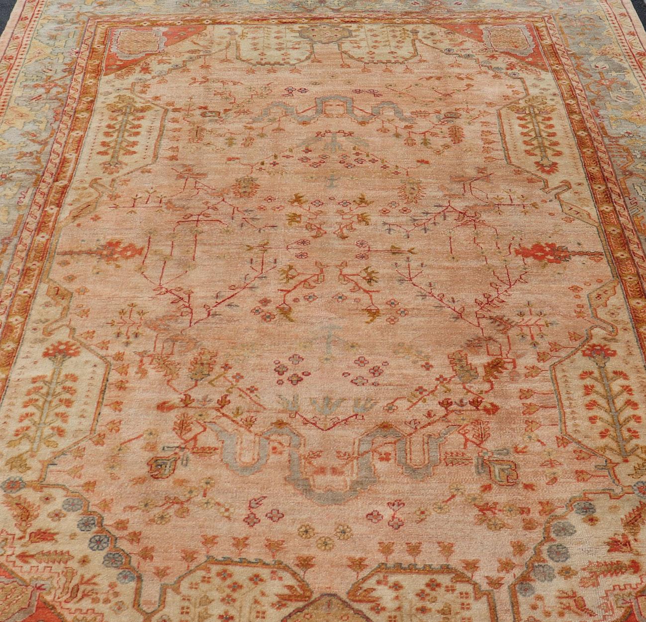 This large late 19th century antique turkish oushak rug displays a colorful palette in Salmon, Green, pink, Yellow, Orange, cream, red, Antique Oushak, Keivan Woven Arts; rug S12-1213, Country of Origin: Turkey Type: Antique Oushak Design: Floral,
