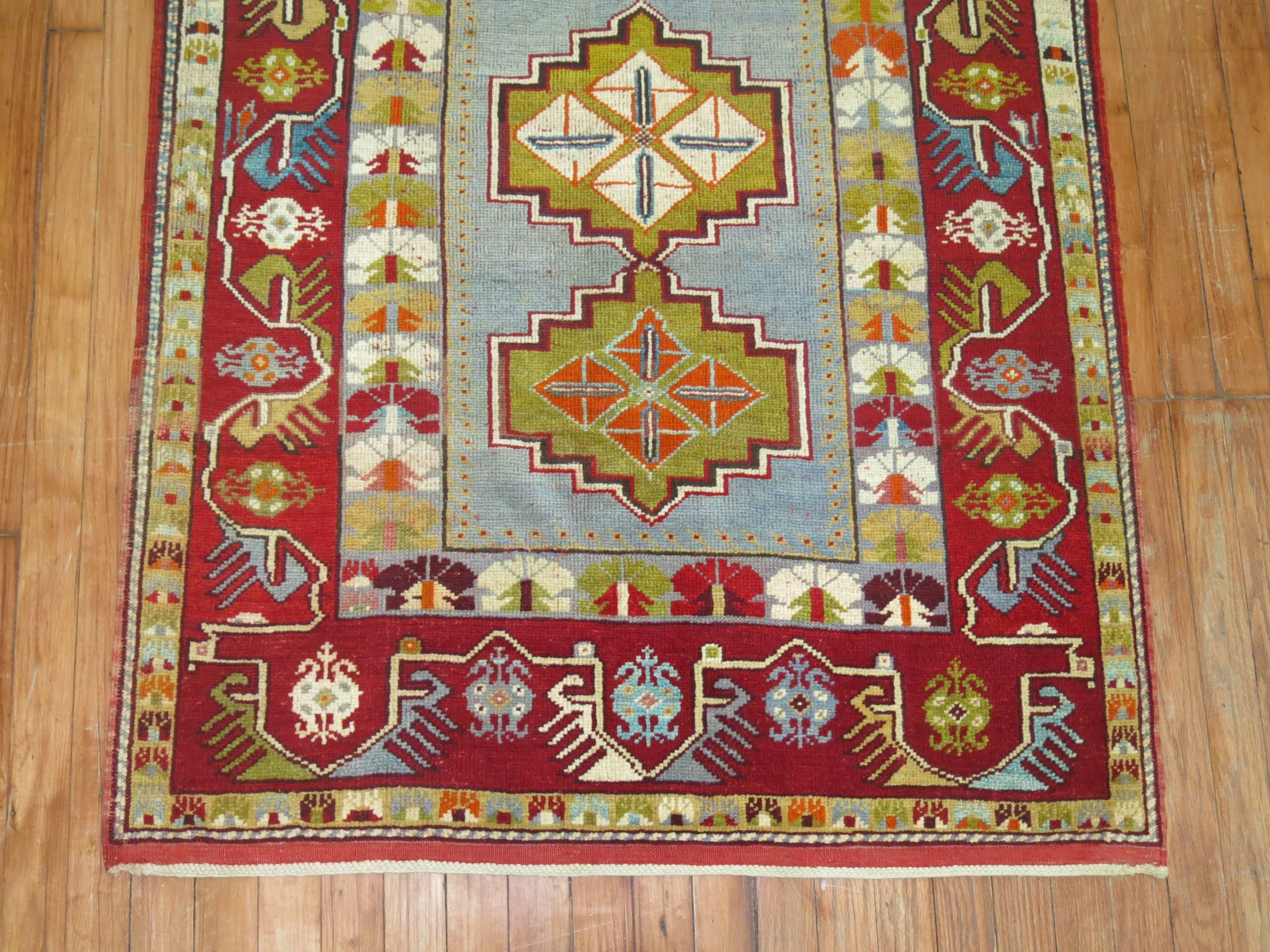 An early 20th century Turkish rug with vivid blues and red.

3'4'' x 4'2''