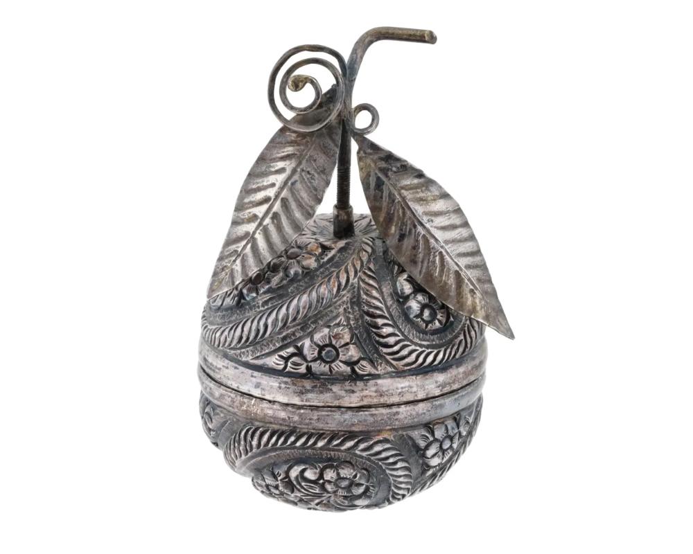 An antique Turkish, Ottoman Empire, Silver engraved box. The fruit shaped box is adorned with engraved floral and foliage designs and a removable screw lid with an elongated stem tube featuring sculpted leaves with scrolls. Circa mid to late 19th