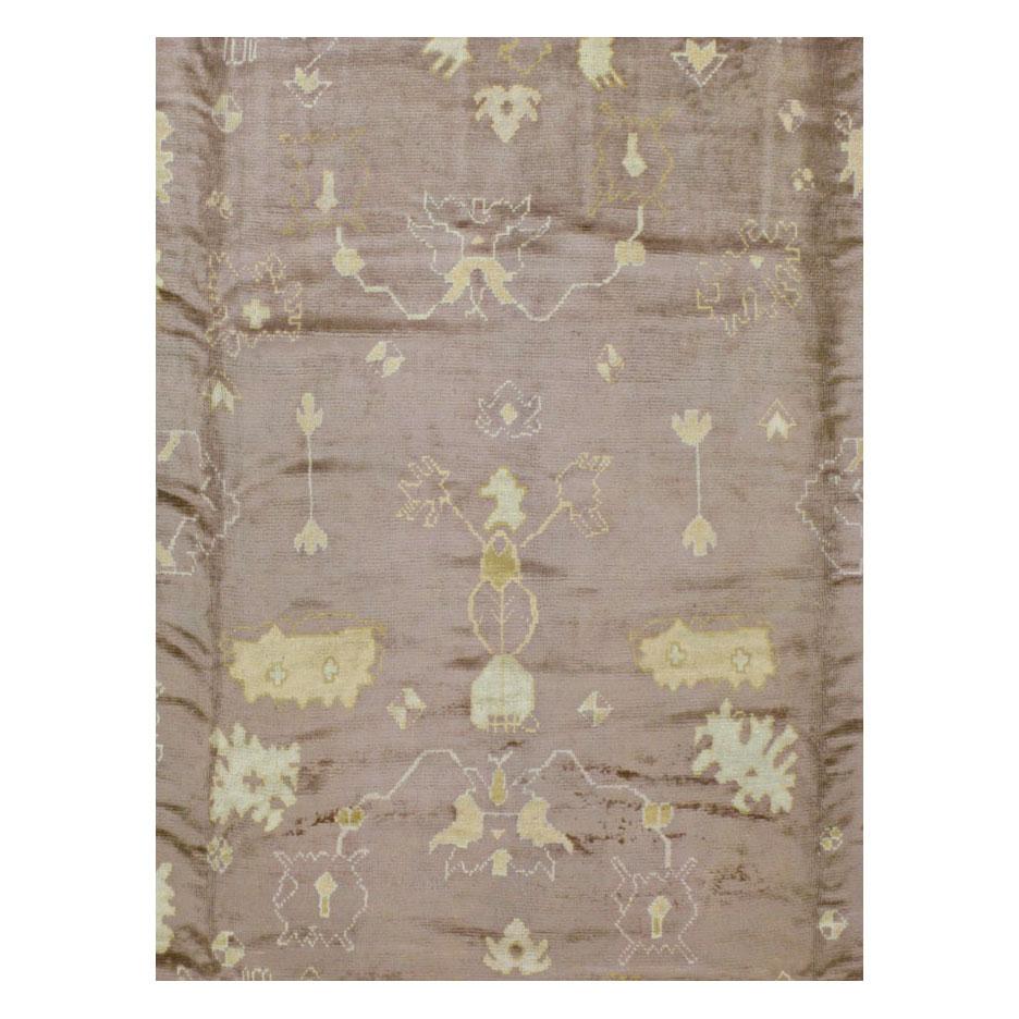A mauve colored antique Turkish Oushak 12' x 15' large room size rug handmade during the early 20th century.

Measures: 11' 11