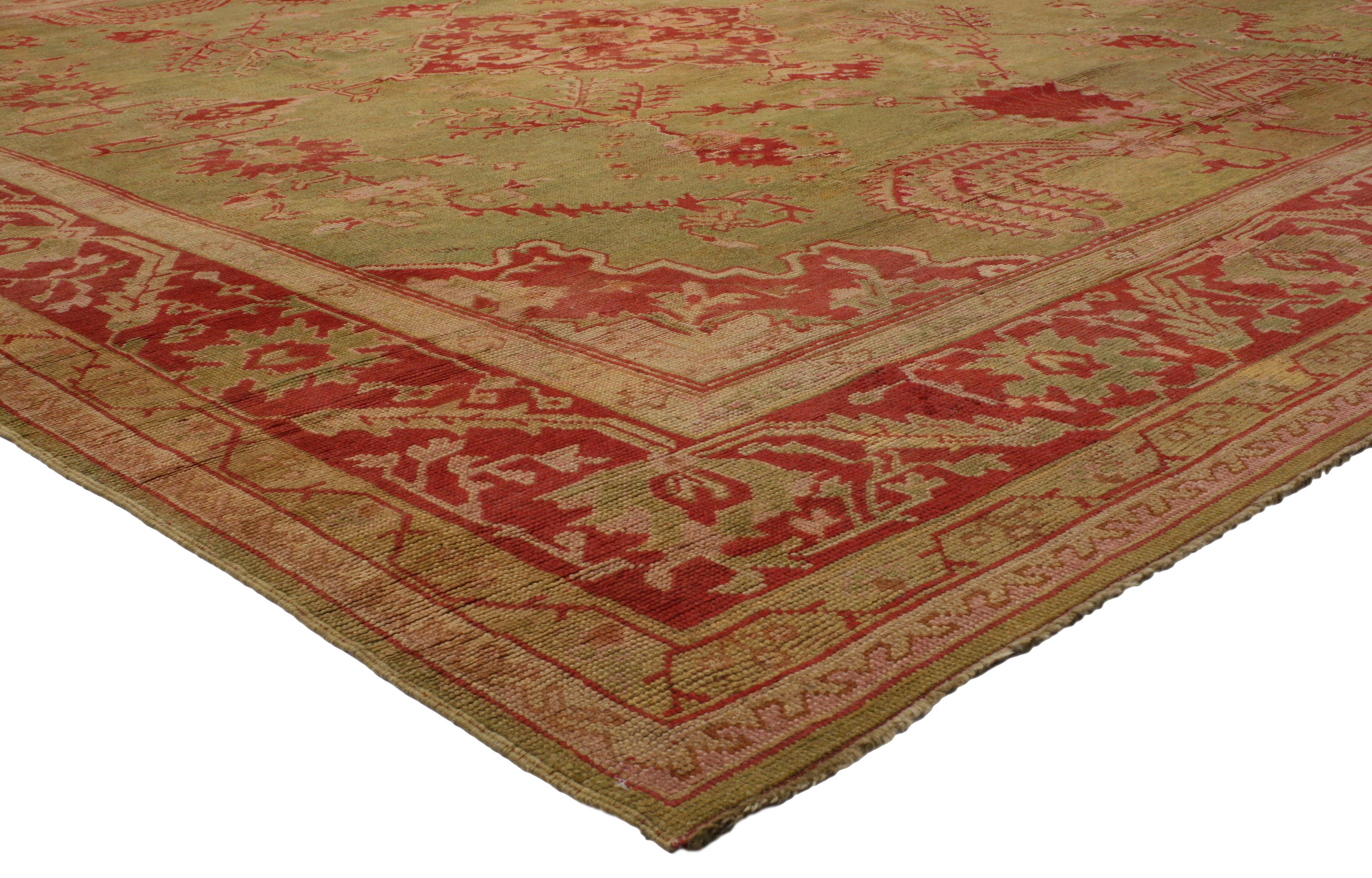 74173 Antique Turkish Oushak Area Rug with Weeping Willow Tree Design. This hand-knotted wool colorful antique Turkish Oushak rug features a red cusped lozenge medallion anchored with palmette finials on an abrashed and subdued pistachio and avocado