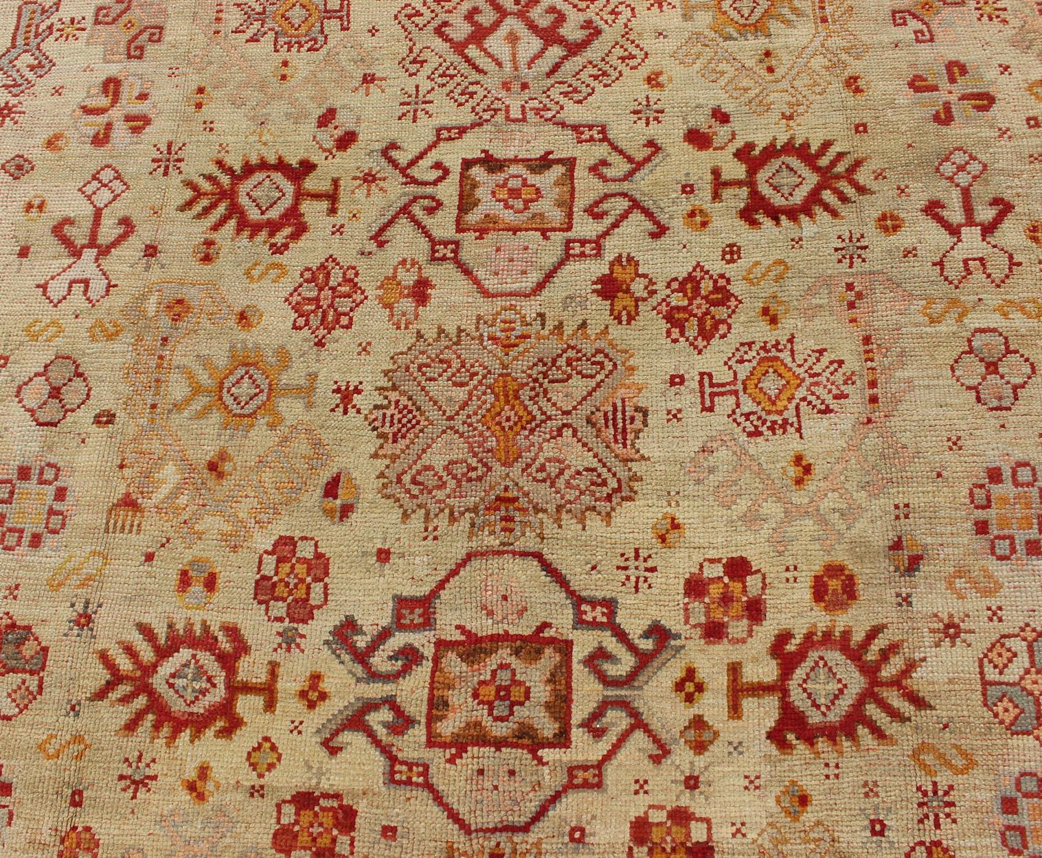 20th Century Antique Turkish Oushak Carpet With All-Over Design In Red, Taupe, and Orange For Sale