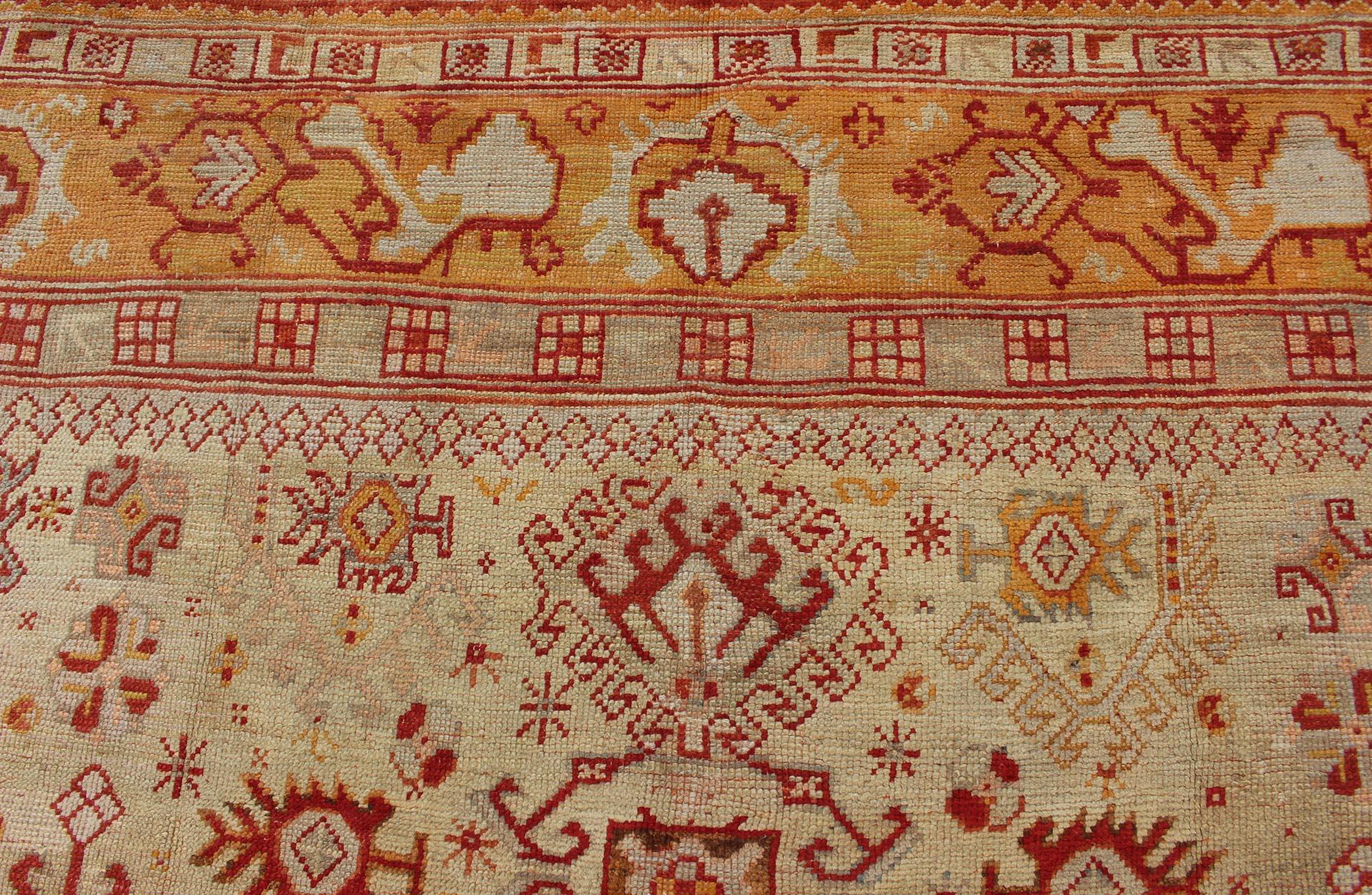 Wool Antique Turkish Oushak Carpet With All-Over Design In Red, Taupe, and Orange For Sale