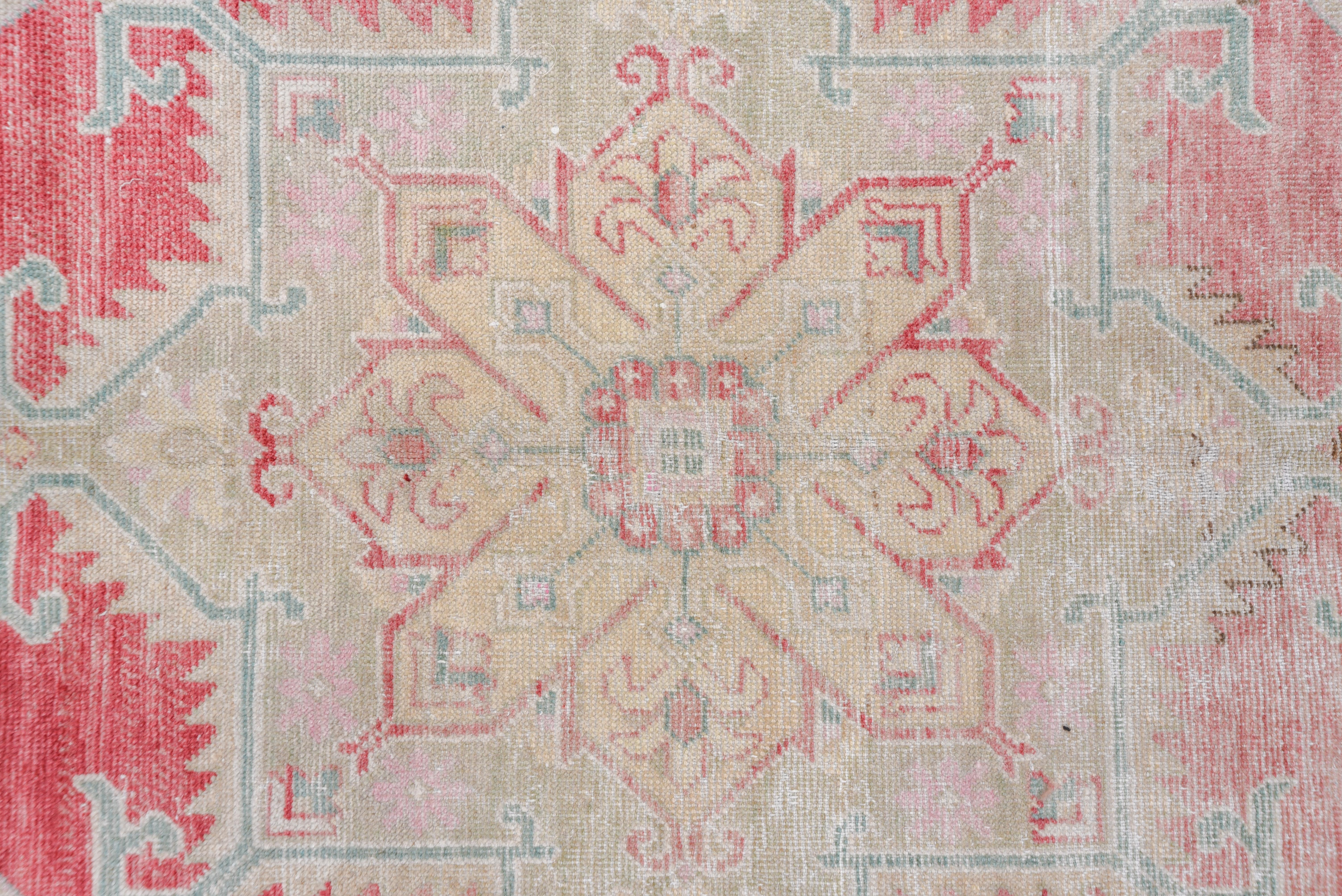 The red field of this oushak carpet strongly abrashes to pale rose wine while displaying a totally pendanted octogramme medallion within a palest green border of cypresses, rosettes and roughly serrated leaves. Straw outer minor band.