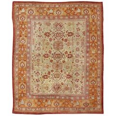 Tapis turc ancien d'Oushak avec motifs sur toute sa surface en rouge, taupe et orange