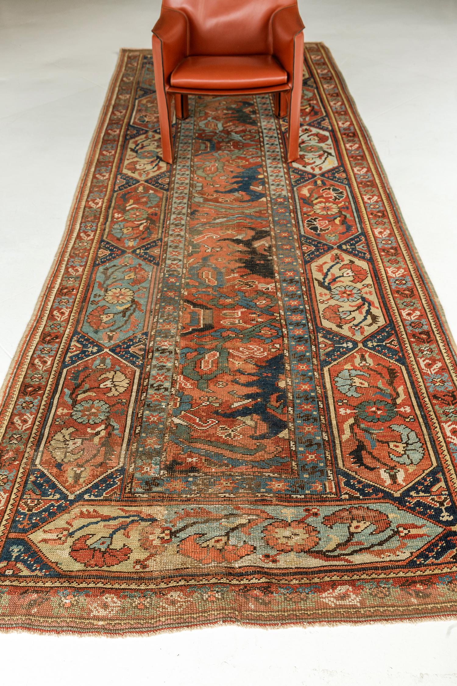 A phenomenal Antique Turkish Oushak rug that features an all-over botanical pattern composed of blooming palmettes, stylized florals, leafy tendrils, organic shapes. It is enclosed with a botanical hexagonal lozenge border flanked with inner and