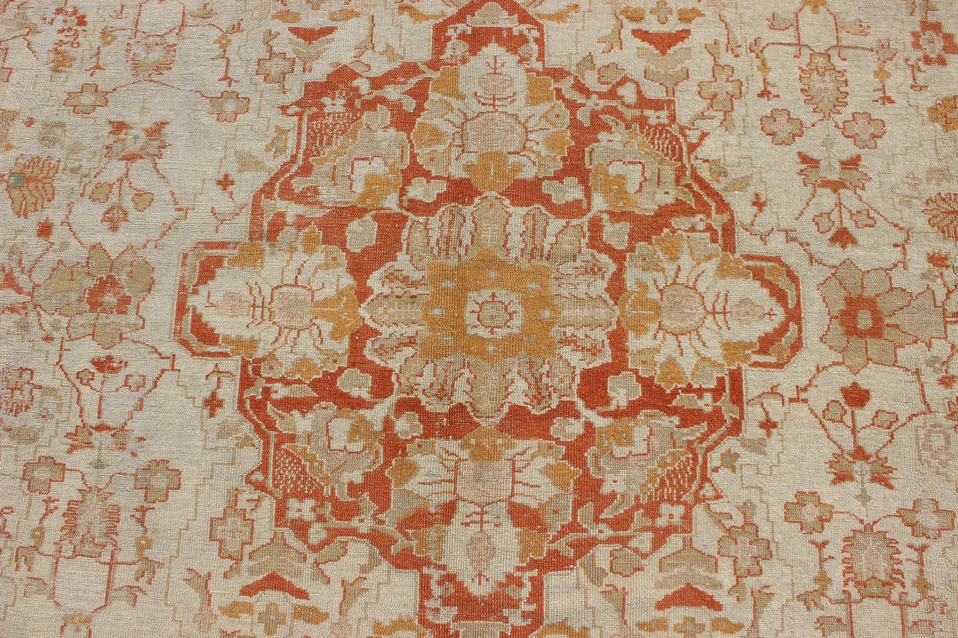 Wool Antique Turkish Floral Oushak Rug in Cream,  Rust Red, Orange and Green   For Sale