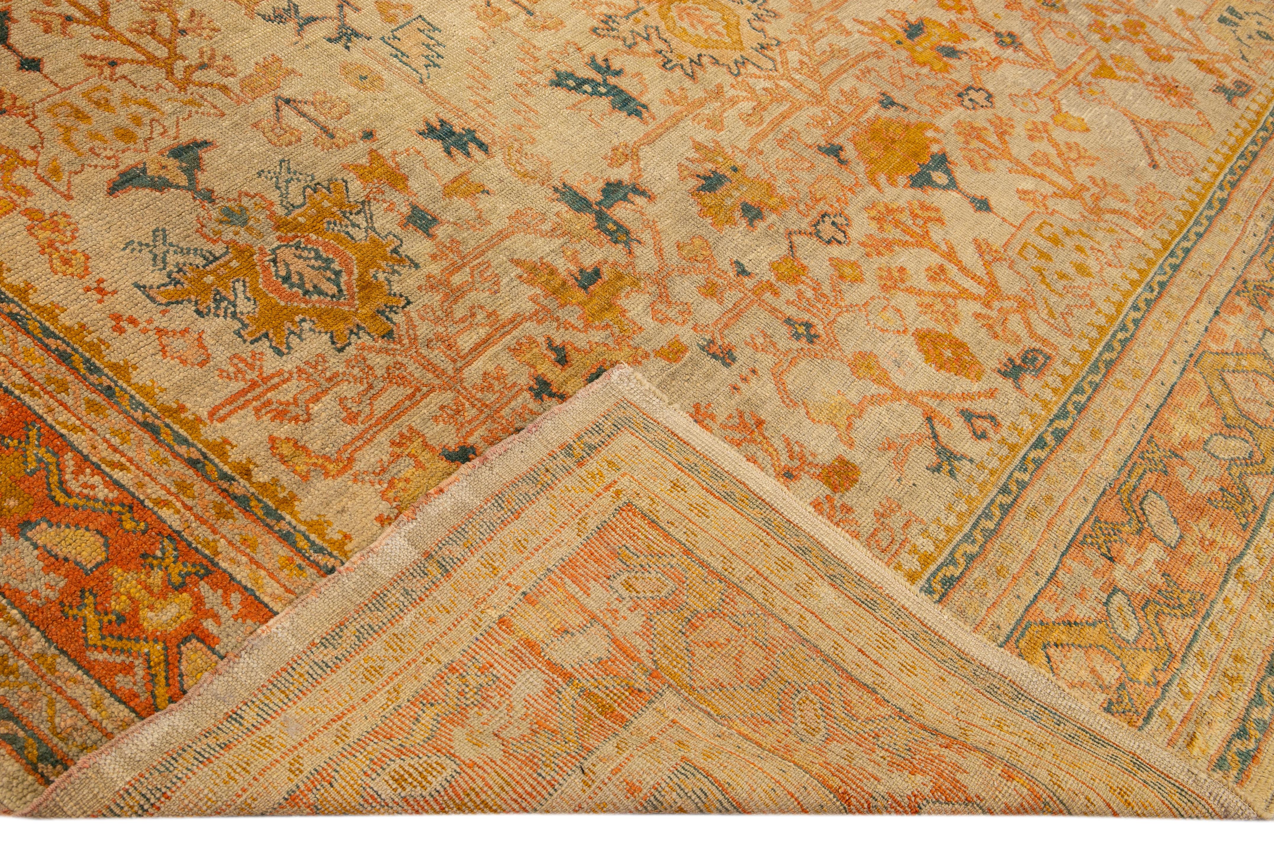 Beautiful vintage Turkish hand-knotted wool rug with a beige field. This rug has accents of orange and peach in a gorgeous all-over geometric floral design,

This rug measures: 10'5