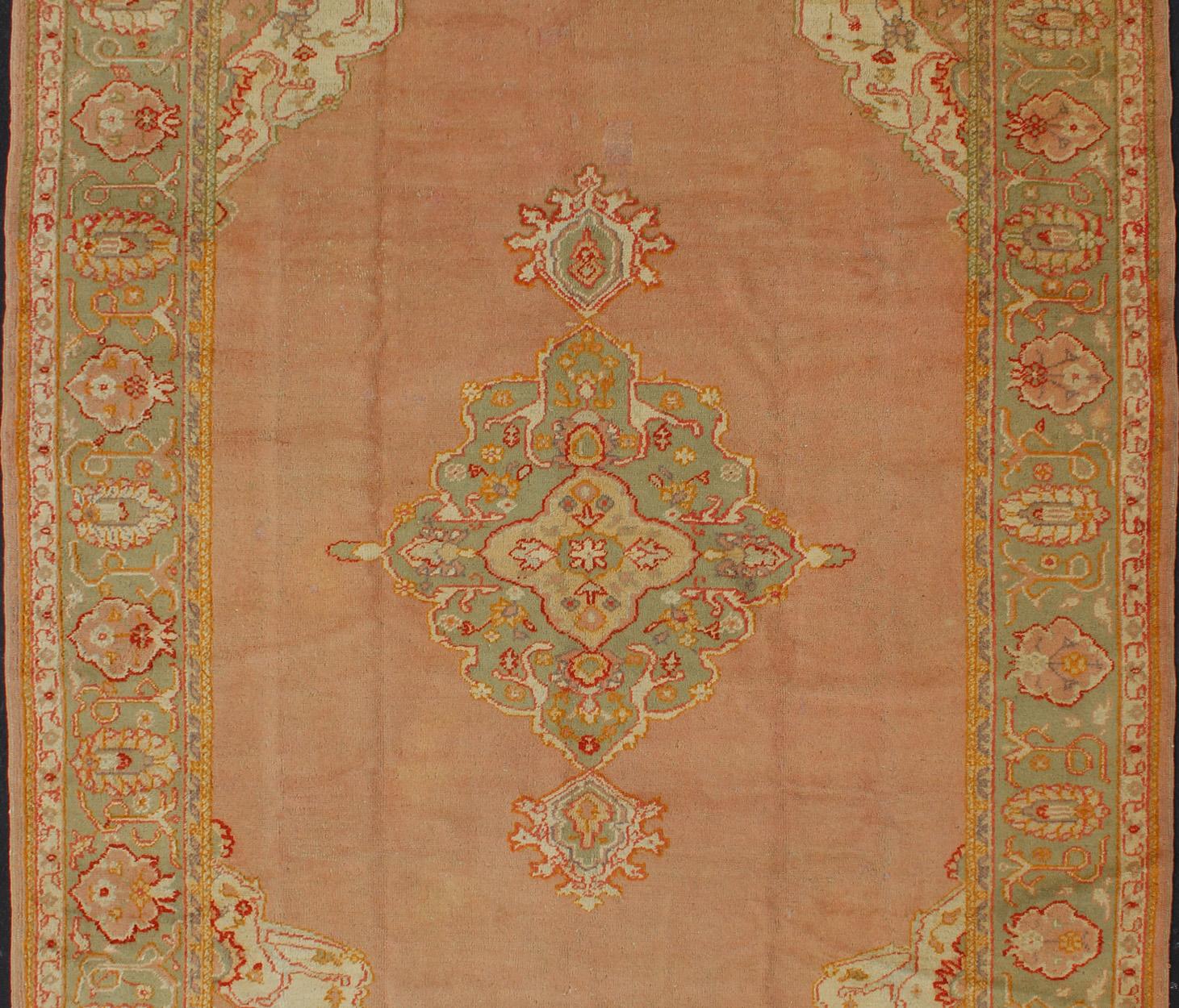 Hand-Knotted Antique Turkish Oushak in Pink Background and Light Green Border For Sale