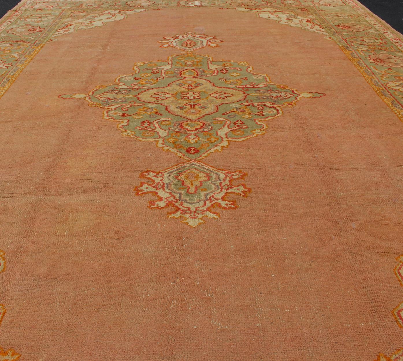 Mid-20th Century Antique Turkish Oushak in Pink Background and Light Green Border For Sale