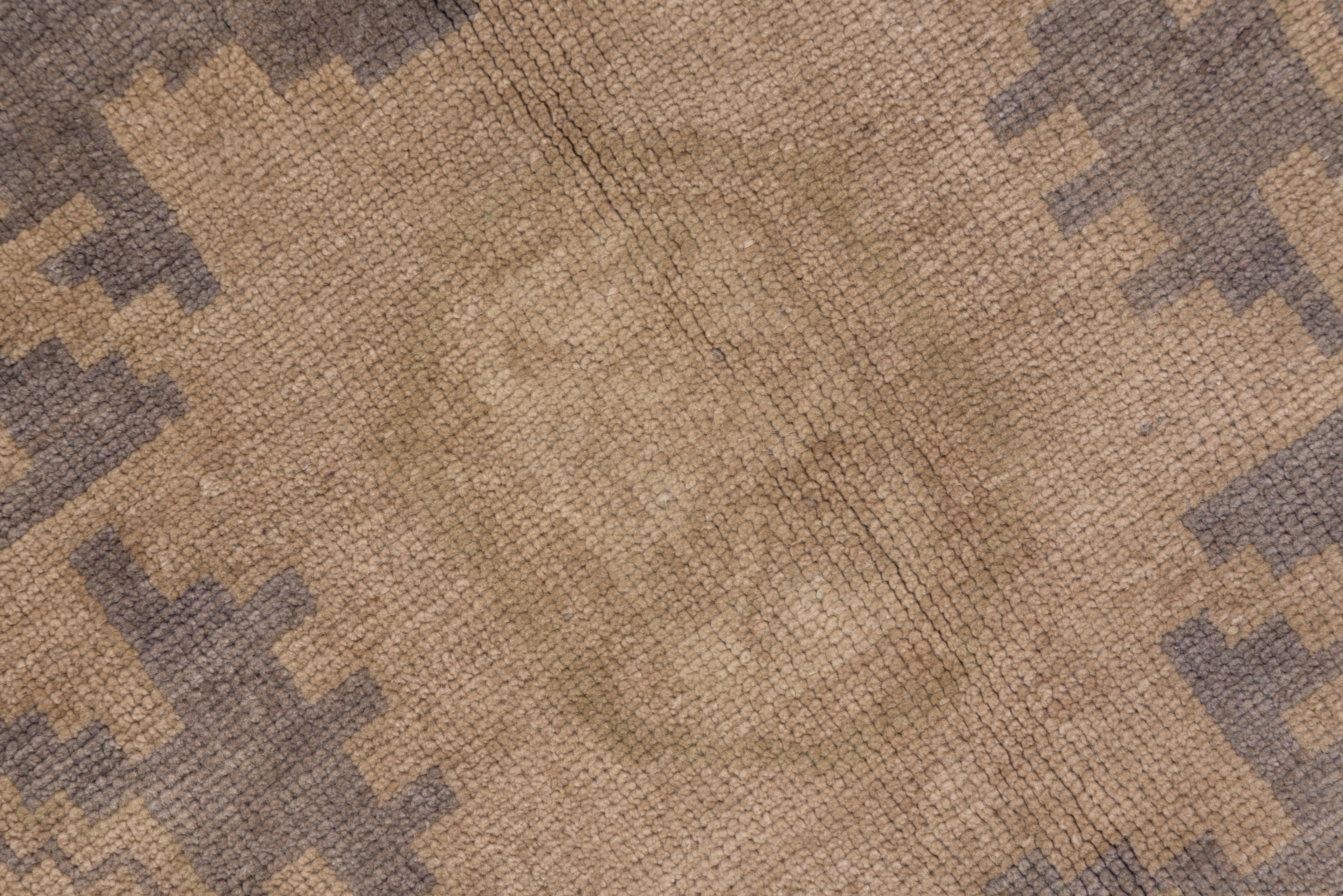 The buff-beige field of this long Turkish scatter features four Caucasian Lesghi stars. The four borders all feature octagonal rosettes. The condition is fairly good, with uniform wear. Straw and graphite are among the mellow detail tones.