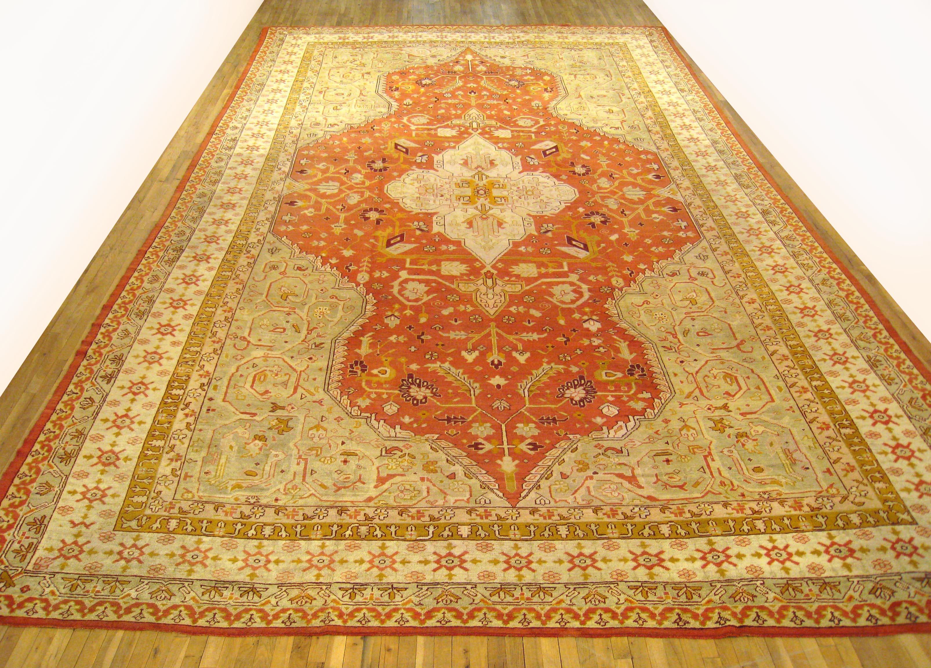 A palace sized antique Turkish Oushak carpet, circa 1900, size 22'7 x 13'9. This grand carpet features a small medallion within a larger medallion shaped primary field, creating a unique visual effect of multiple medallions arising from one another.