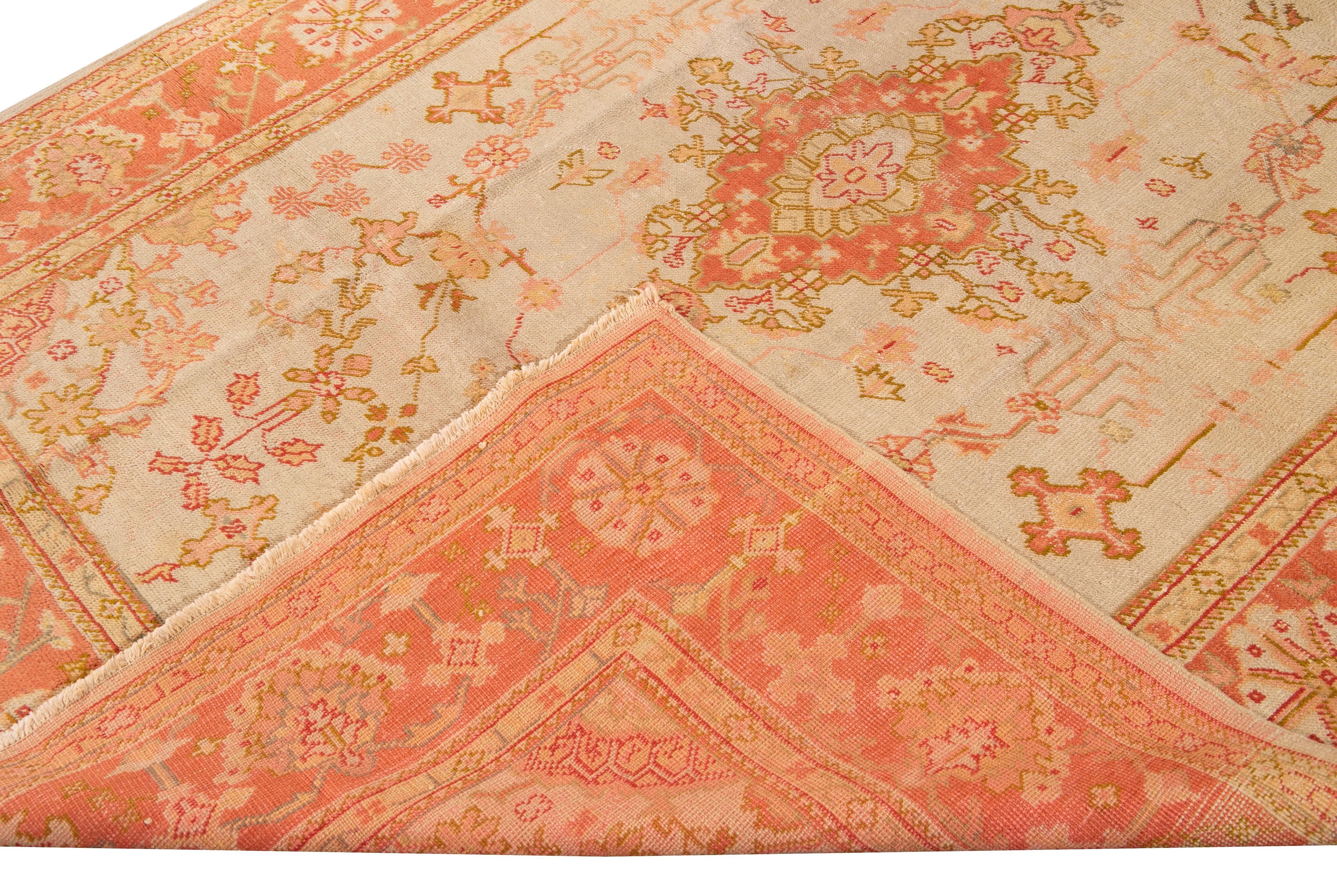 Beautiful antique Turkish Oushak hand knotted wool rug with peach and beige field. This Oushak rug has a frame of peach, pink, and yellow accents in a gorgeous all-over center medallion floral design.

This rug measures: 6'10