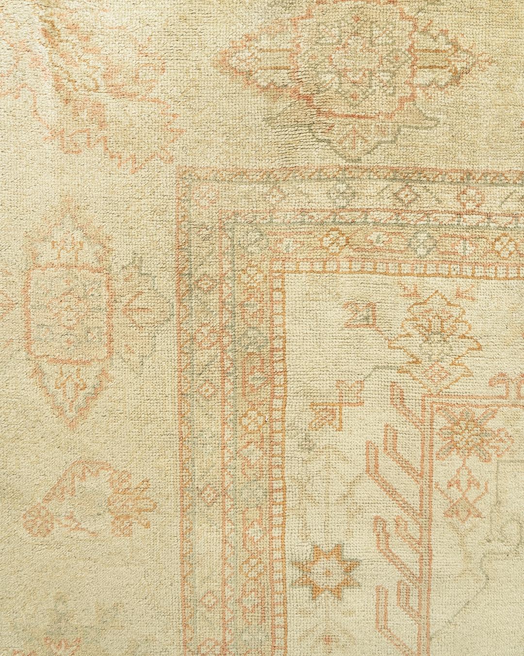 Antique Turkish Oushak rug, circa 1900. Measures: 12'3 x 15'10. The plain soft field with delicate floral and vine designs creates a harmonious feel. Oushak's are known for their soft palettes combined with eccentric drawing. Oushak in western