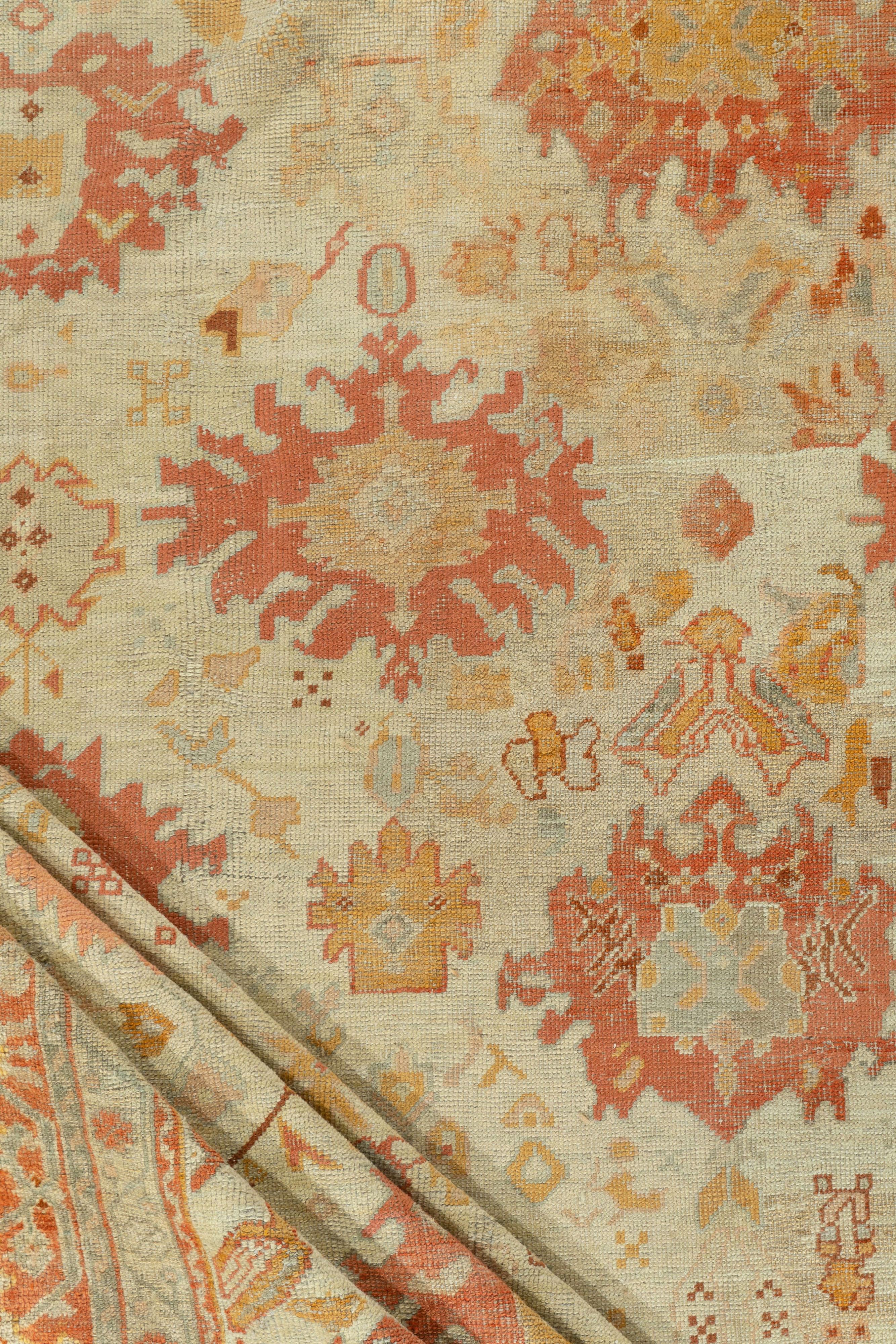 Ancien tapis turc Oushak 13'7 x 17'. Ce tapis de ville tissé à la main présente un motif Harshang éclaté, composé de palmettes flottantes, de losanges, de médaillons déchirés et de palmettes symétriques, le tout sur un fond beige crème, soutenu par