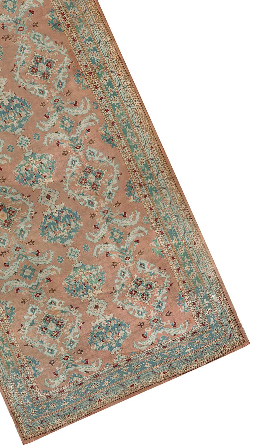 This Antique Turkish Oushak rug is a testament to the timeless beauty and craftsmanship of traditional Turkish weaving. Handwoven with the utmost care and attention to detail, this luxurious wool rug showcases a captivating blend of colors and