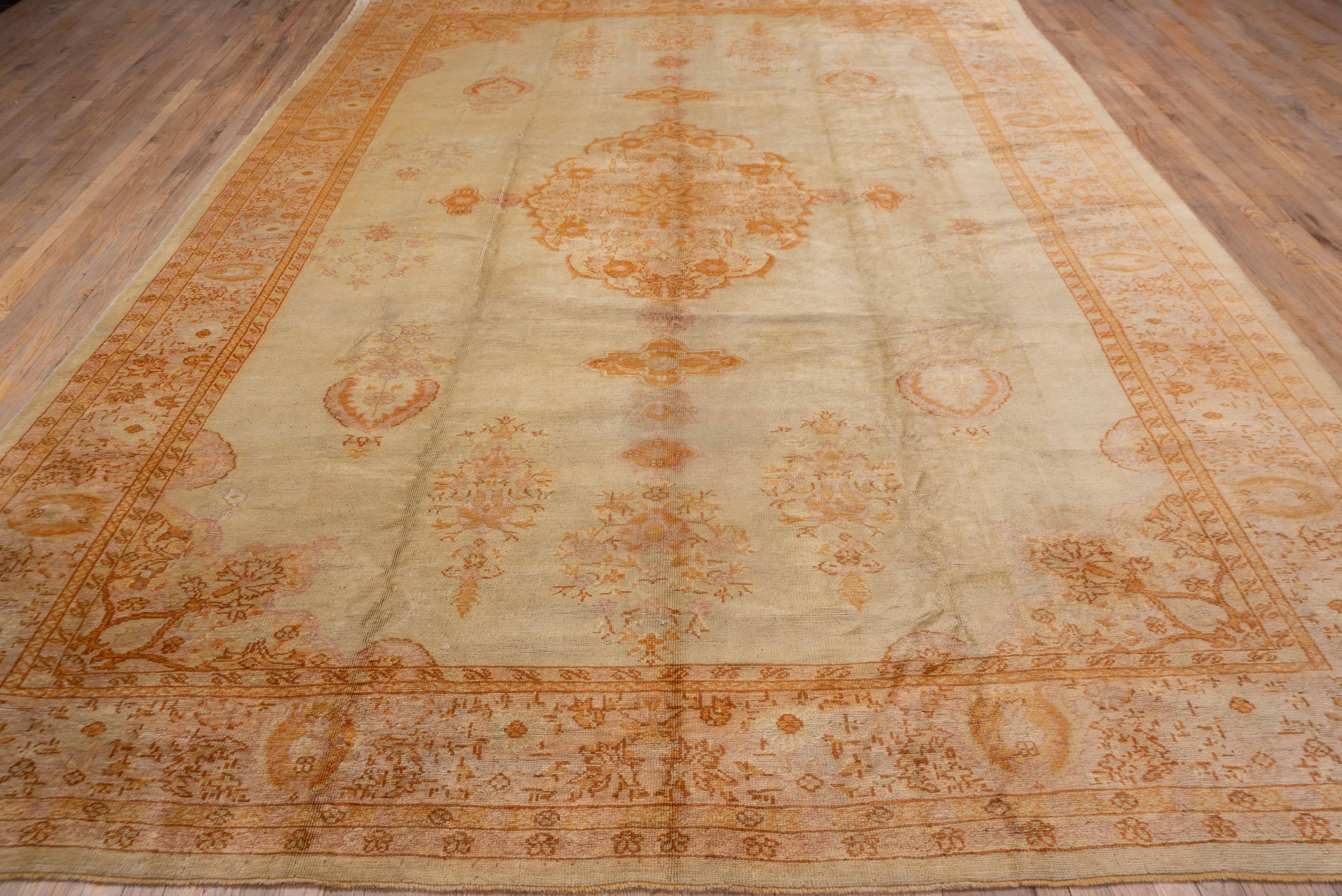 Antique Turkish Oushak Rug, Ecru Field, Center Medallion, Orange & Pink Accents In Good Condition For Sale In New York, NY