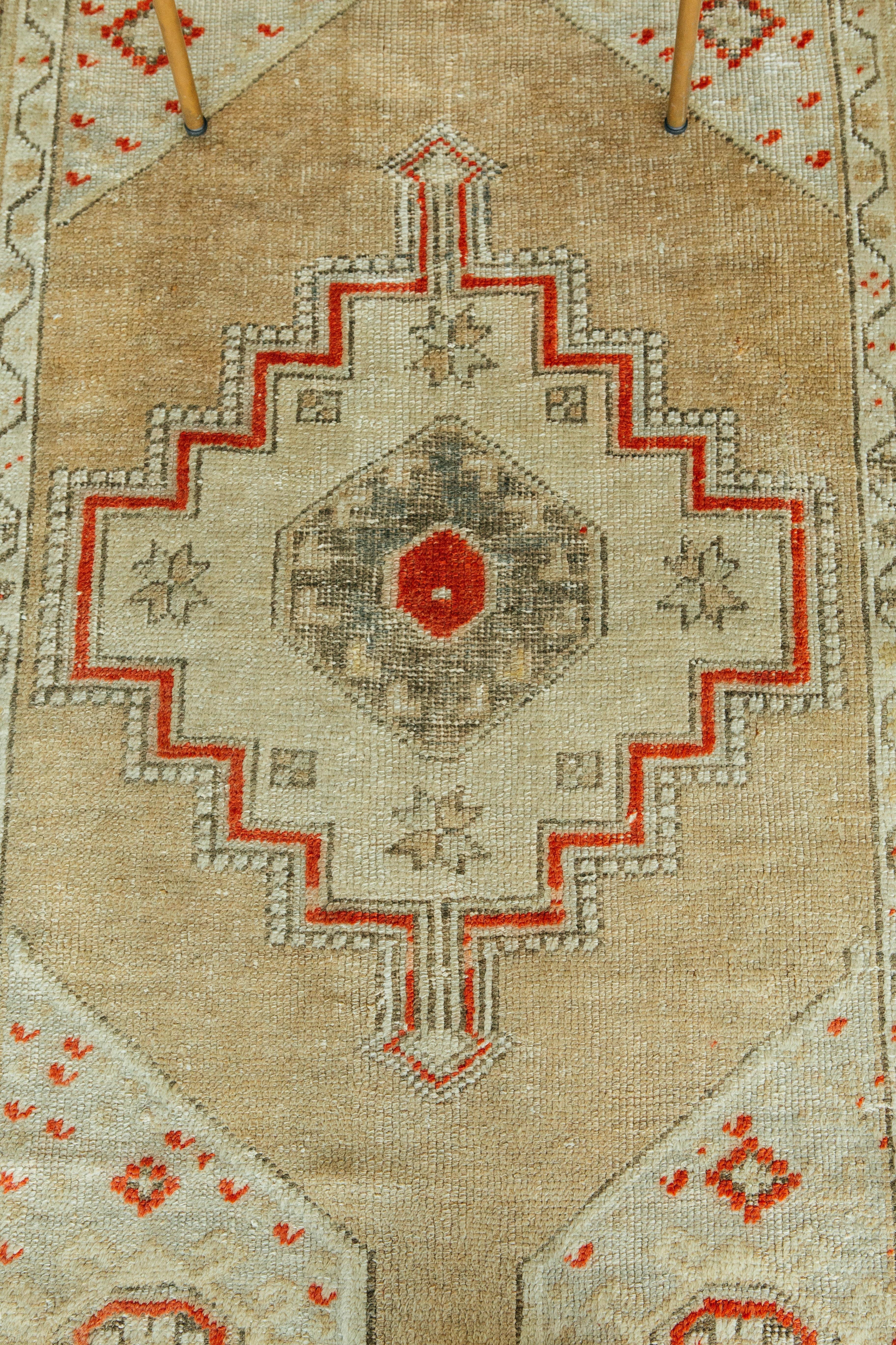 A divine antique Turkish Oushak rug. This piece encompasses a tasteful geometric design. Neutral tones and an antique red gives the piece just the right amount of color. Oushak rugs originated in the small town of Oushak in west-central Anatolia,