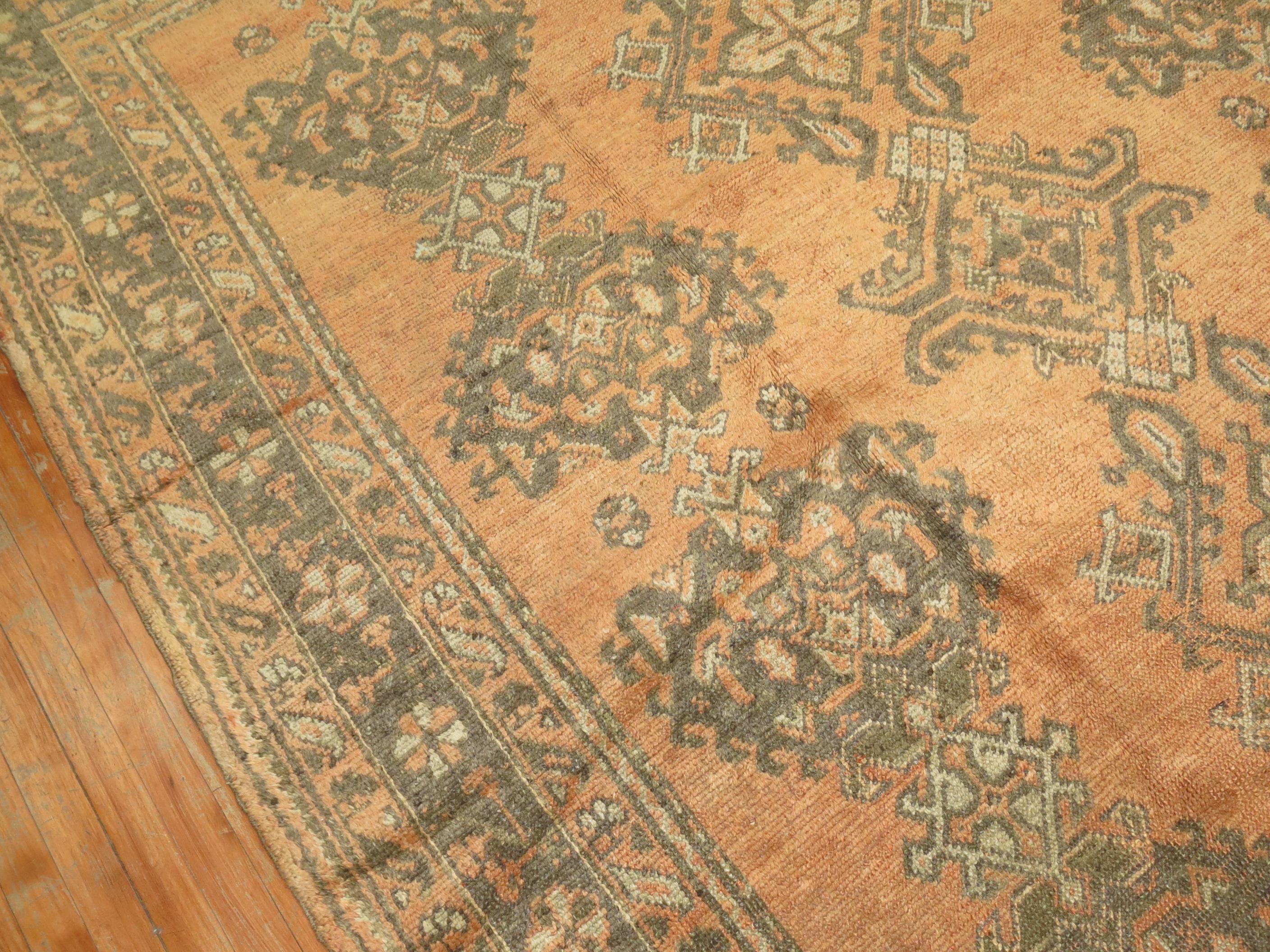 An early 20th century Turkish Oushak rug. 

Measures: 8'2